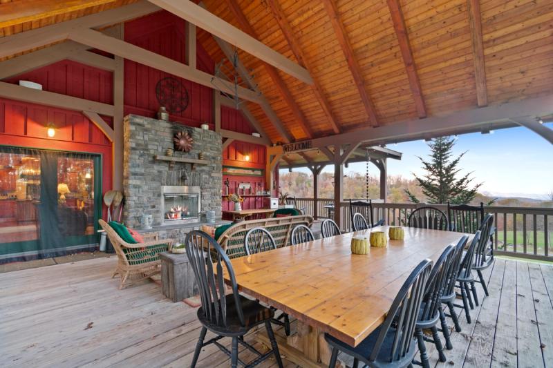 Spacious deck with outdoor dining and fireplace
