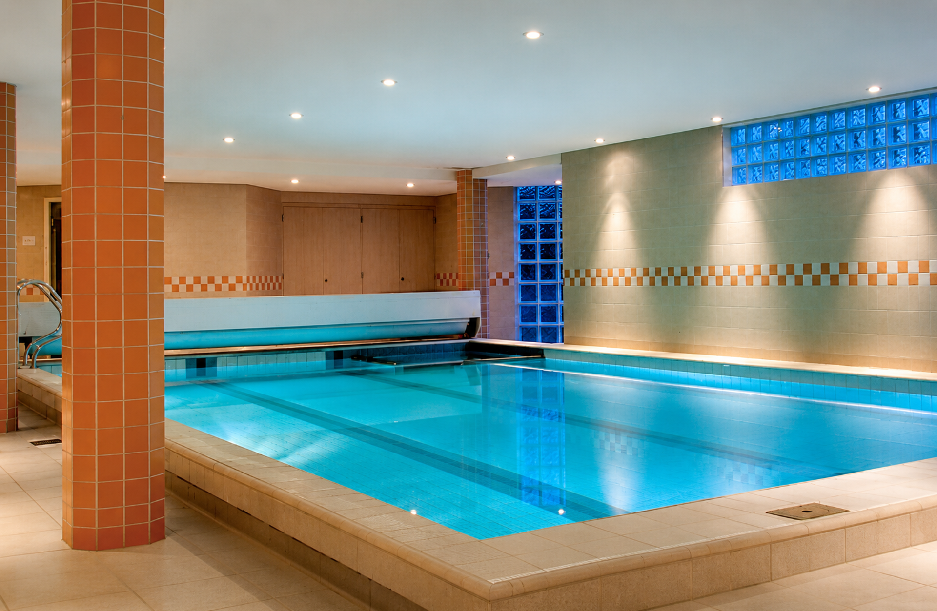 Binnenzwembad met sfeerverlichting en glasblokken bij Hotel Paping Spa & Sauna in Ommen, Vechtdal