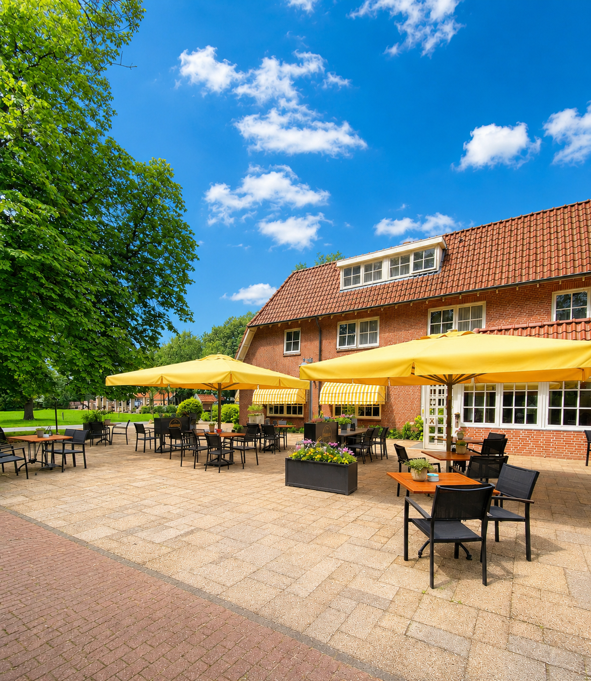 Terras van Hotel De Landmarke in Ootmarsum met ruime zitgelegenheid, zonnige parasols en uitzicht op de natuur van Twente, ideaal voor lunch, diner en borrel.