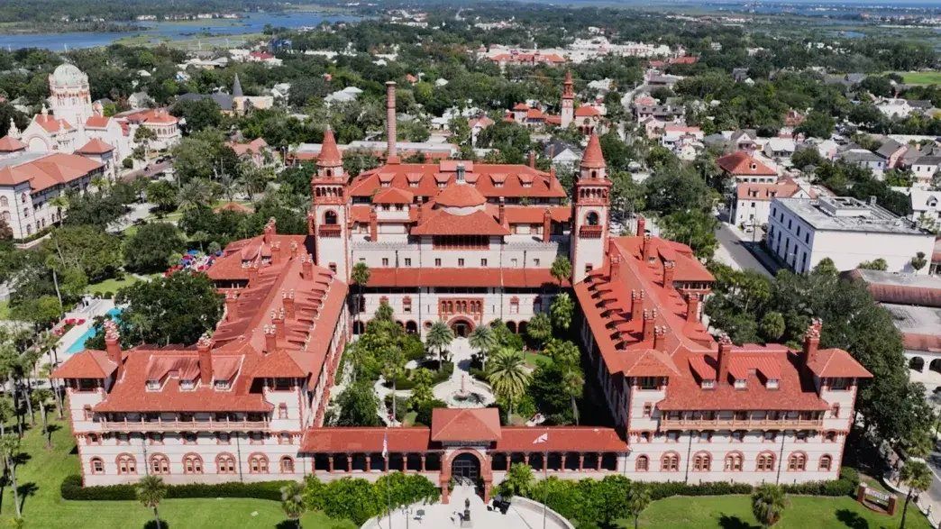 Aerial view of Flagler College's historic red-roofed Ponce de Leon Hall and its towers in St. Augustine, Florida