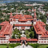 Aerial view of Flagler College's historic red-roofed Ponce de Leon Hall and its towers in St. Augustine, Florida