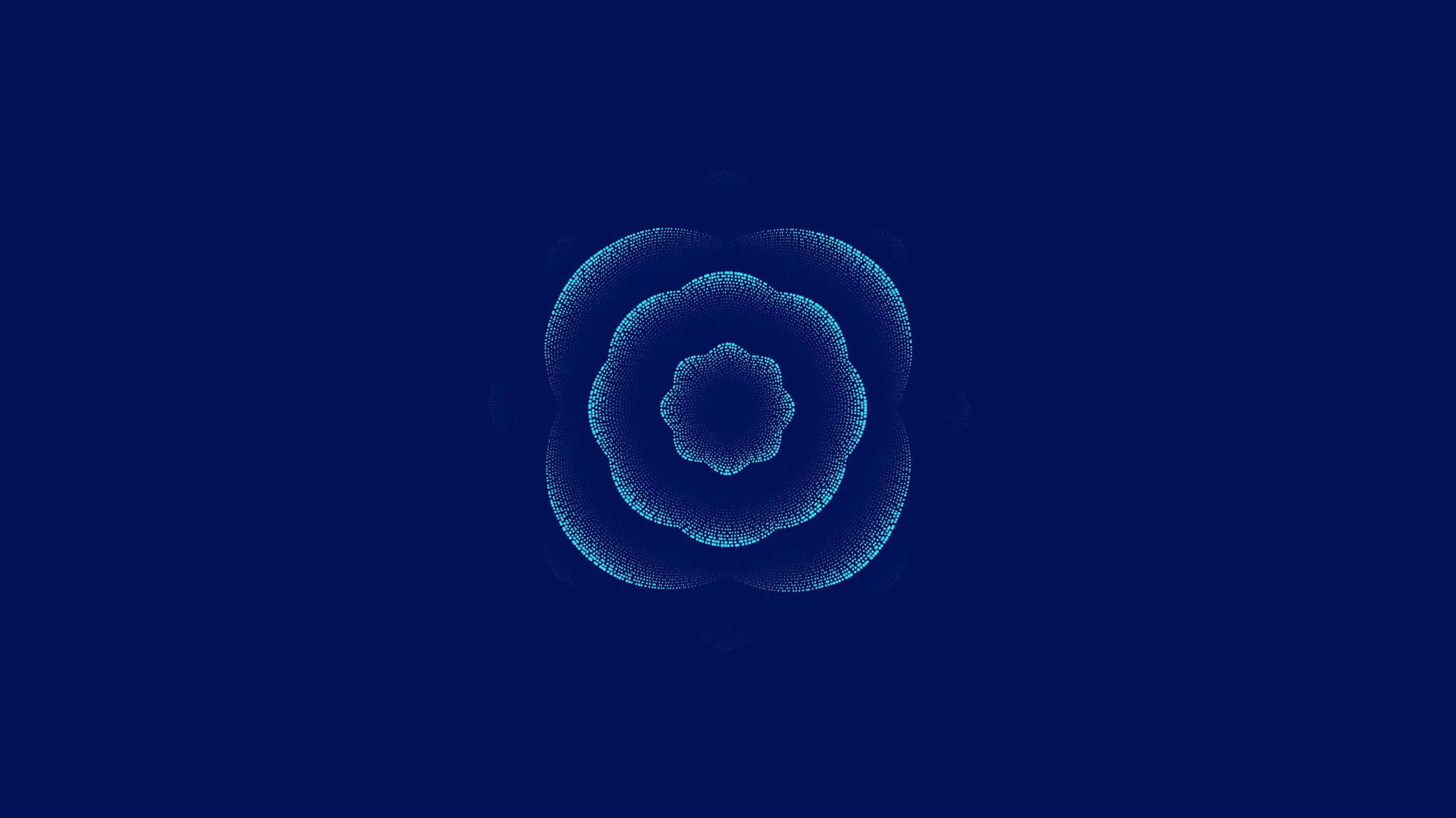 Animated particle artwork: rings of cyan dots ripple outward from the centre of a navy field and change shape.