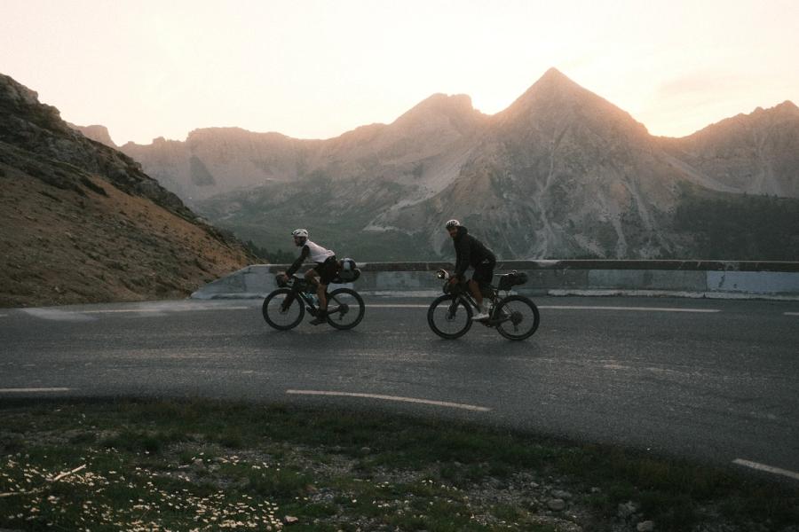 Two cyclist climbing in the alps