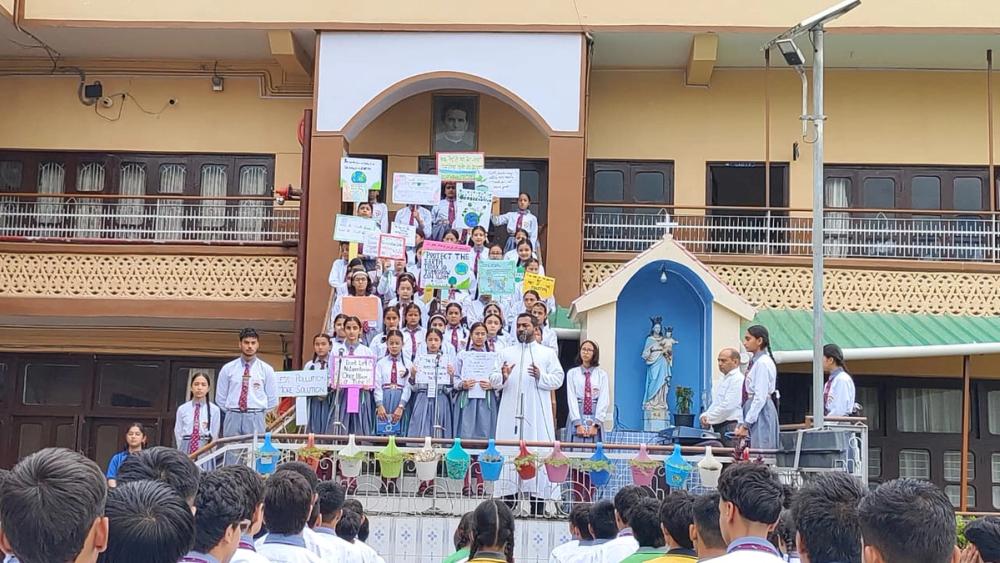 Fr. Michael Collins, the principal addresses the students and the staff to be real custodians and ambassadors of God's creation.