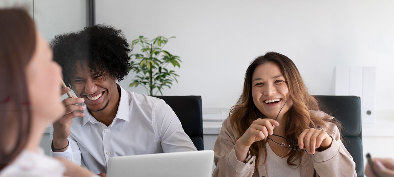 Happy young office workers laughing