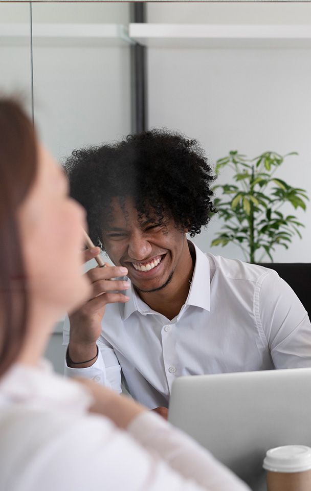 Happy young office workers laughing