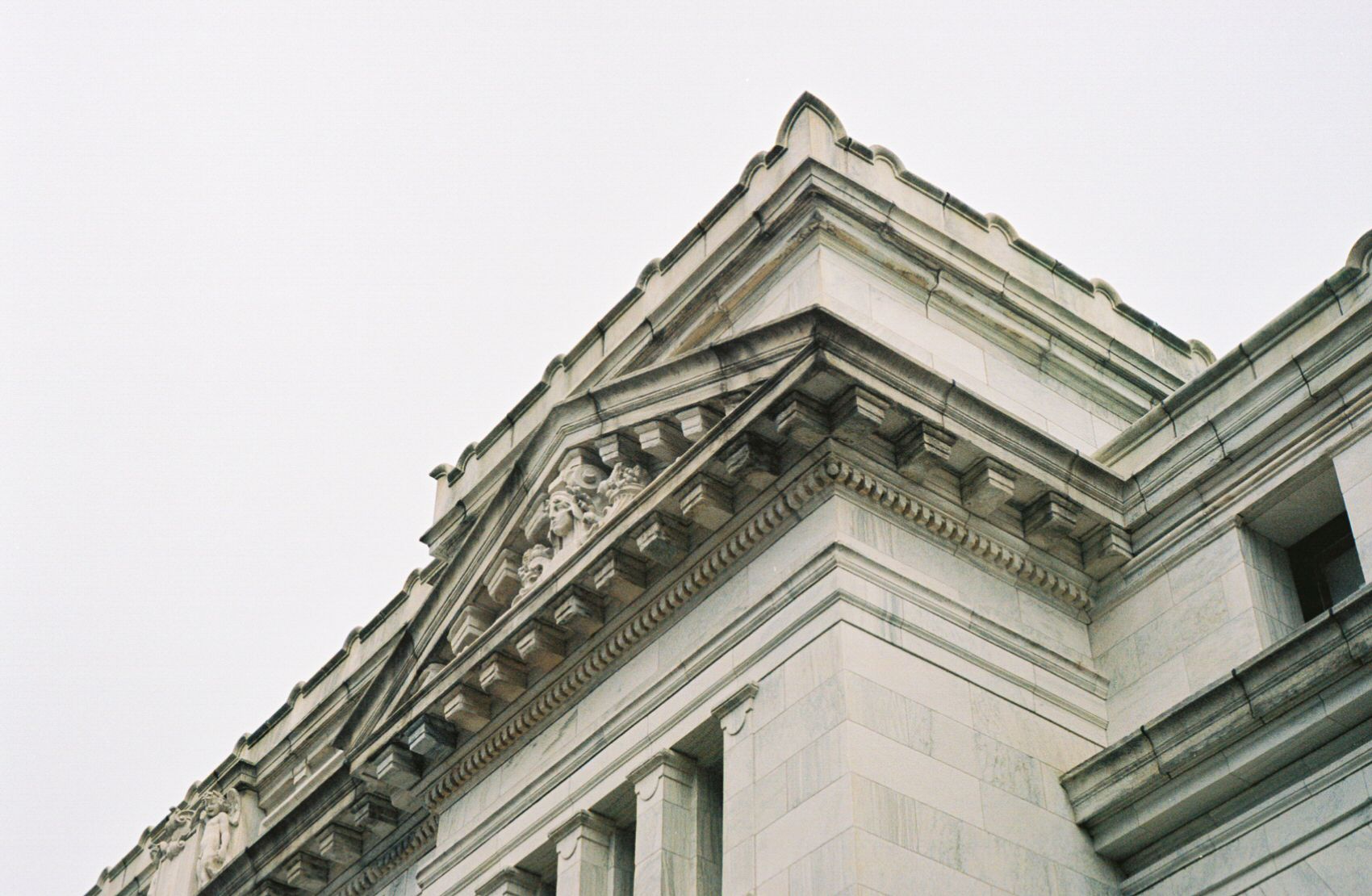 A 35mm film photograph of architectural elements (cornices and pediment) on the Carnegie Library of Washington, DC Apple Store