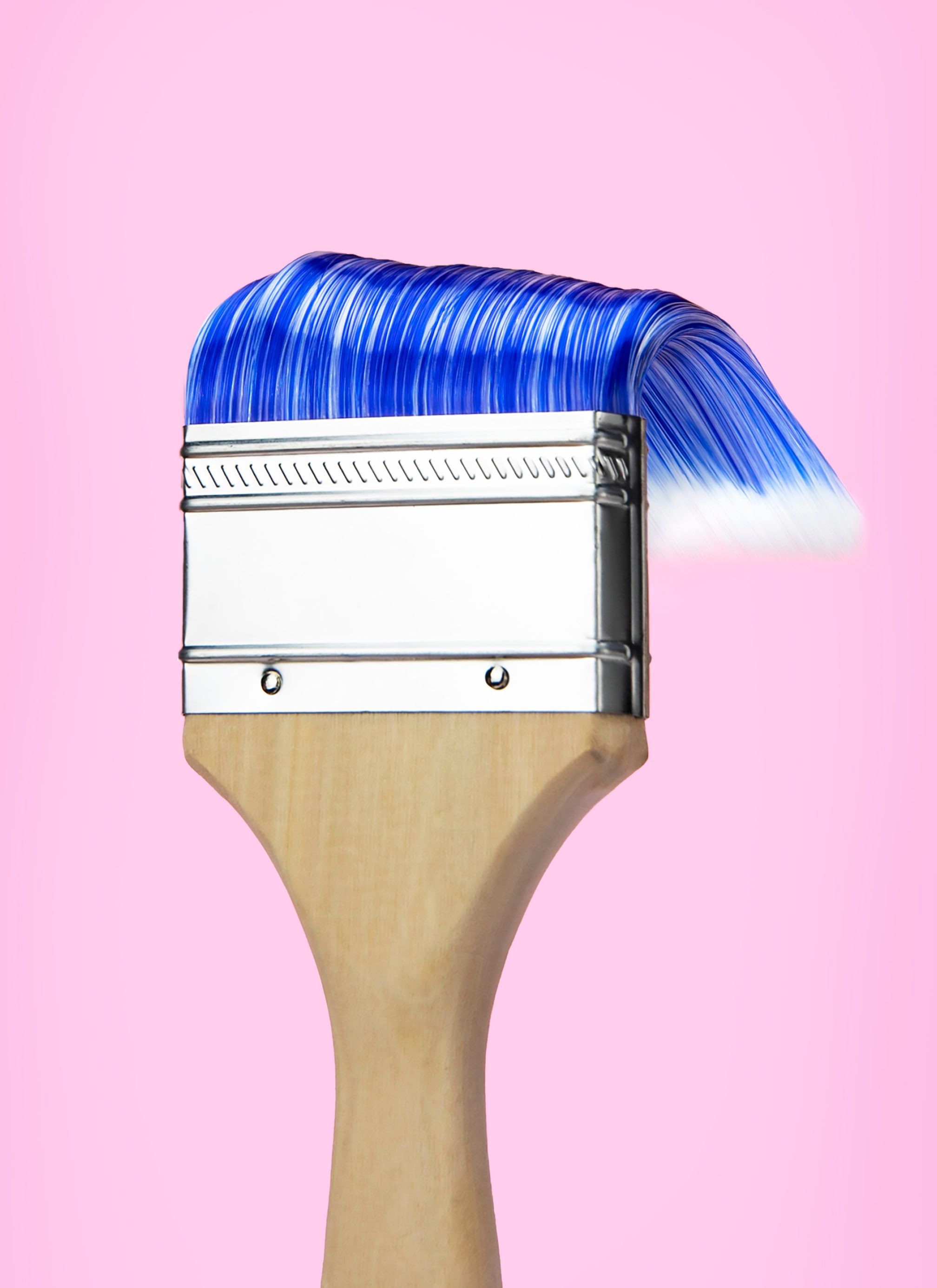 A blue paintbrush with its bristles slicked back like hair.