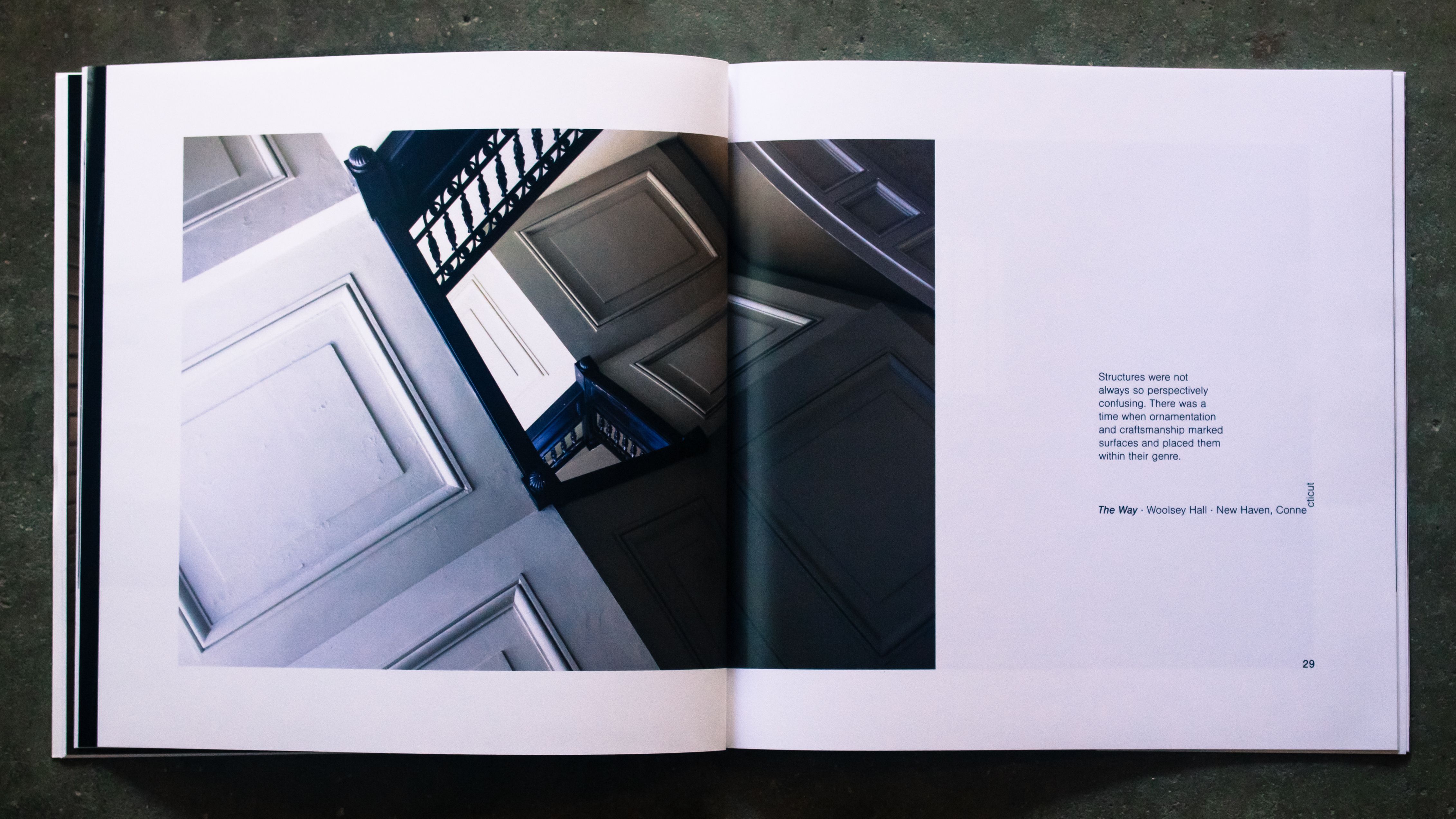 A spread with a rotated photo of a classical white stairwell and text.