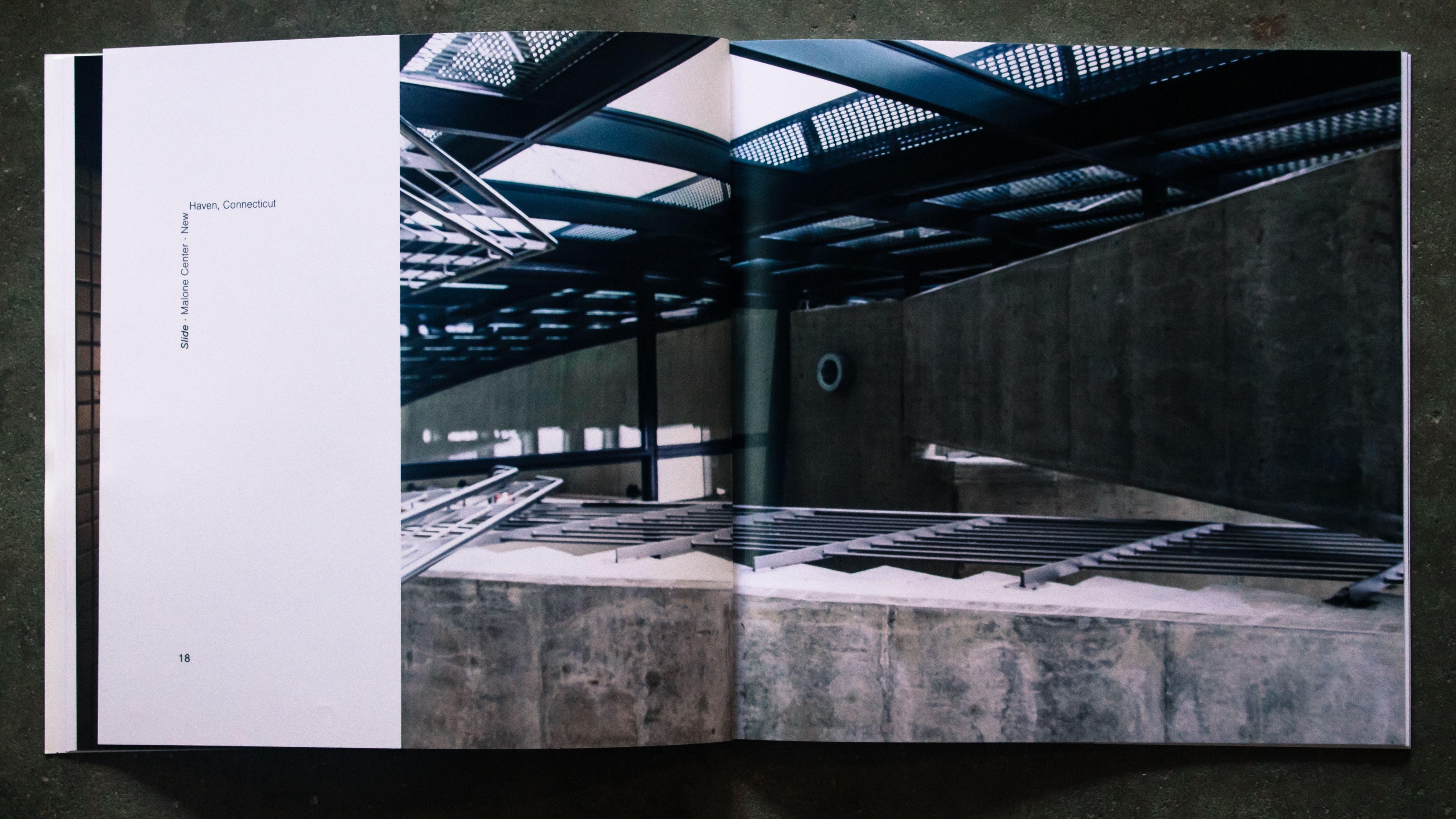 A spread with typography and a rotated photo of a concrete stairwell.