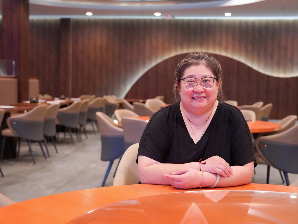 A restaurant owner photographed inside her dining room