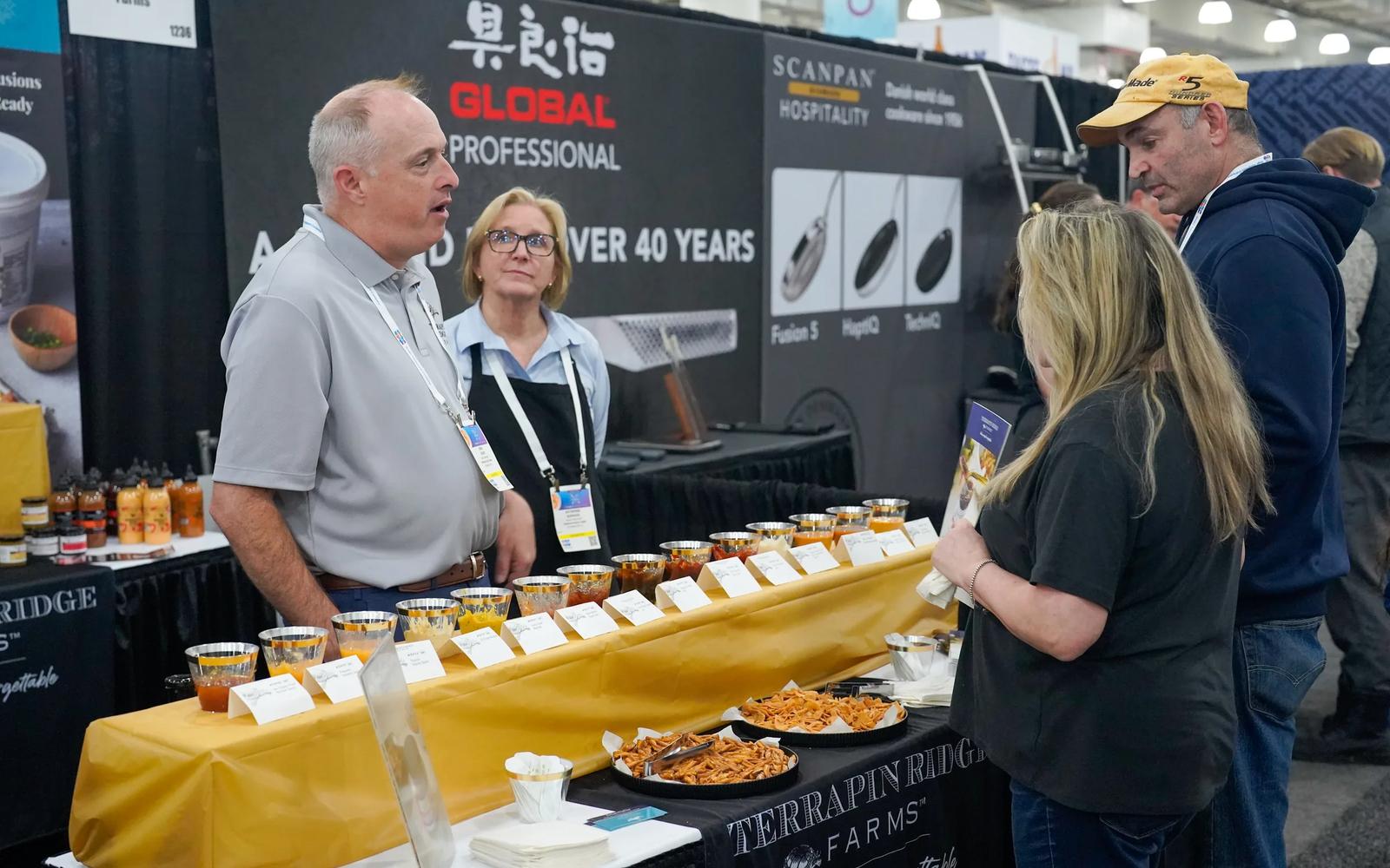 A supplier presenting products to restaurant professionals at an industry expo