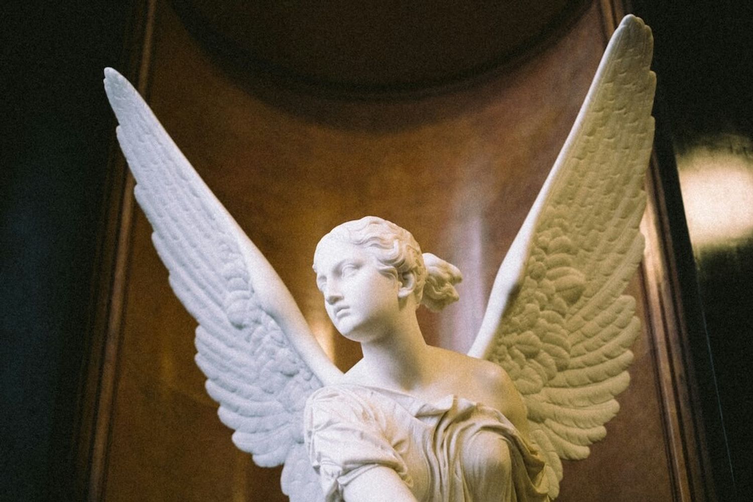 A majestic angel sculpture with outstretched wings, symbolizing guidance and support for startups from angel investment networks