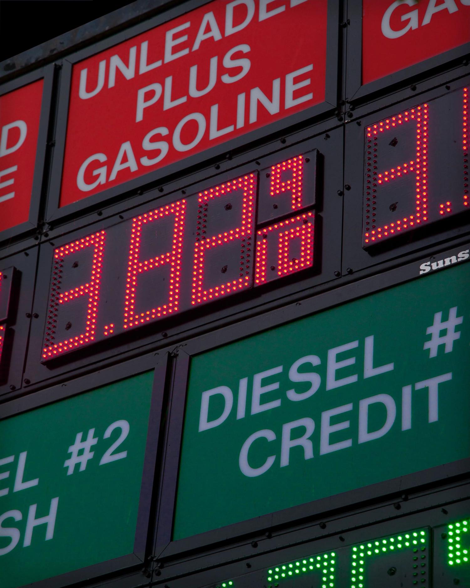 A gas station price board displaying fuel costs, symbolizing financial challenges for startups in a recession.