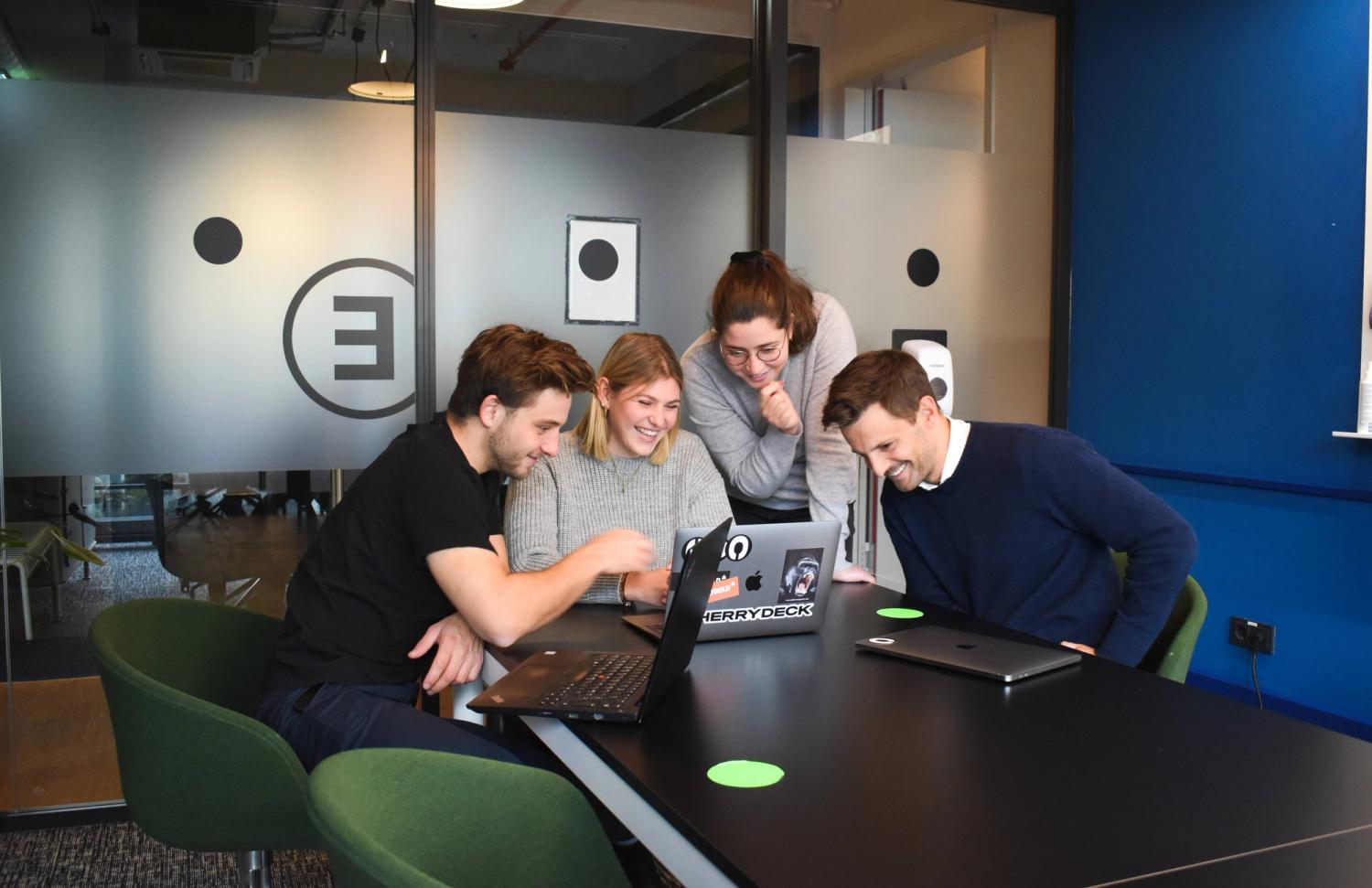 two males and two females smiling and discussing what is a tech lead and its responsibilities