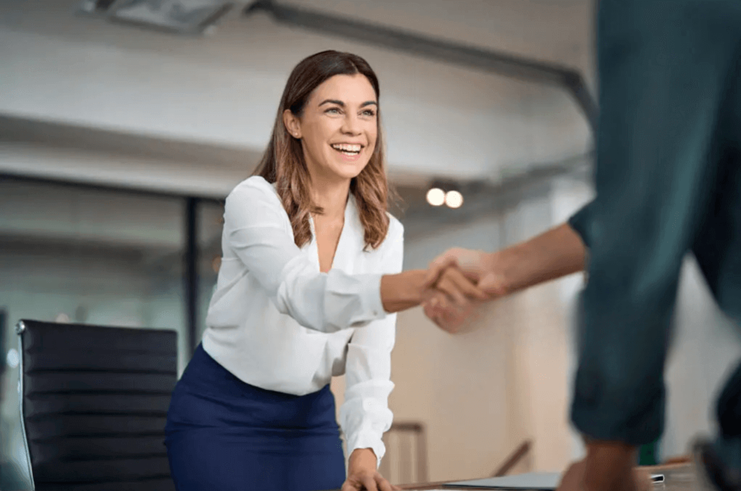 Two people shaking hands, symbolizing a successful partner relationship management PRM