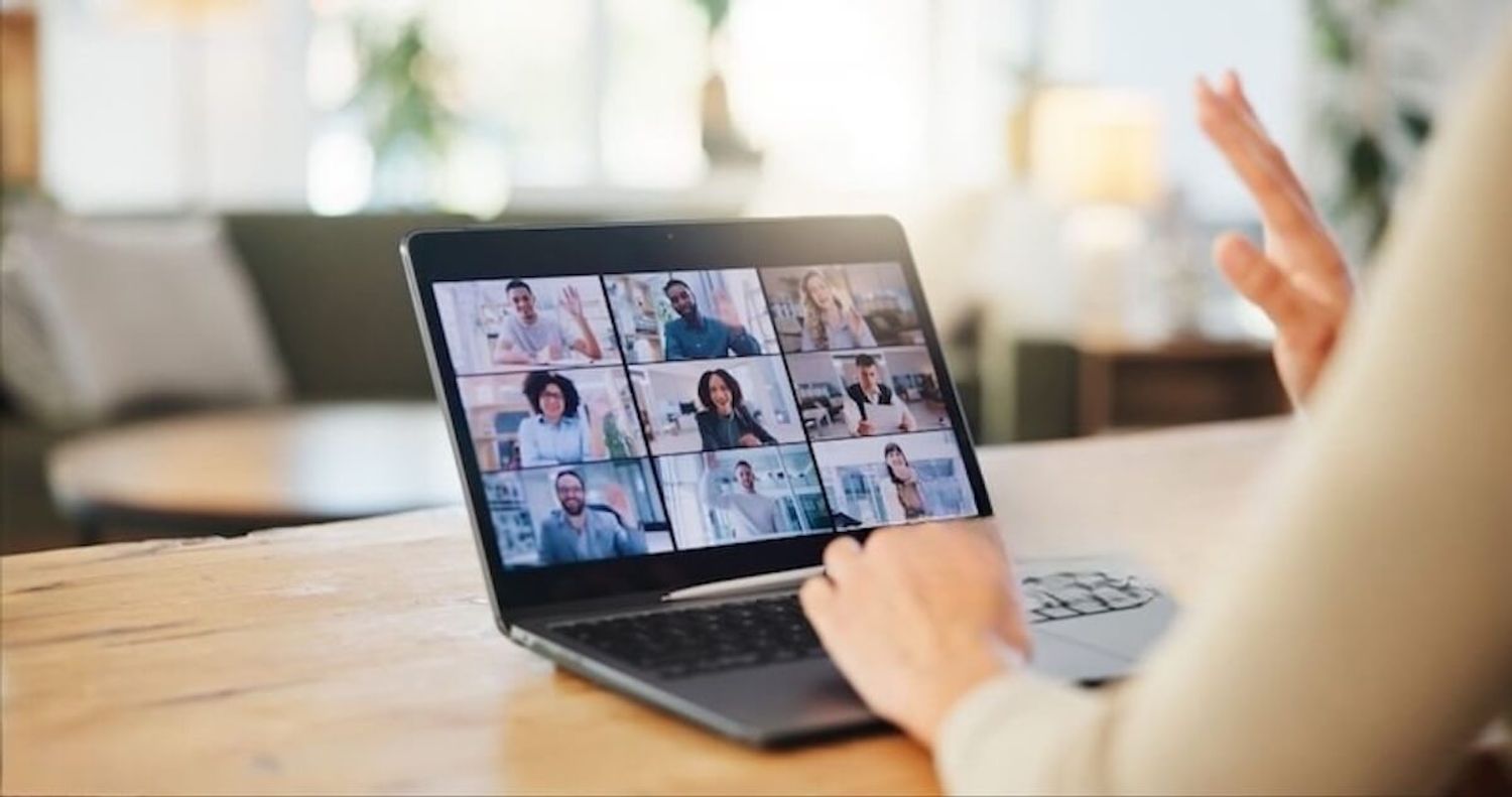 Laptop screen showing a Zoom meeting with team members collaborating remotely.