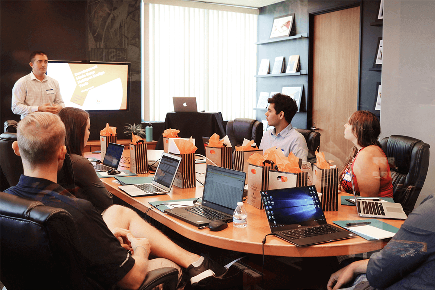 A boardroom with a group of people discussing startup equity stake and ownership.