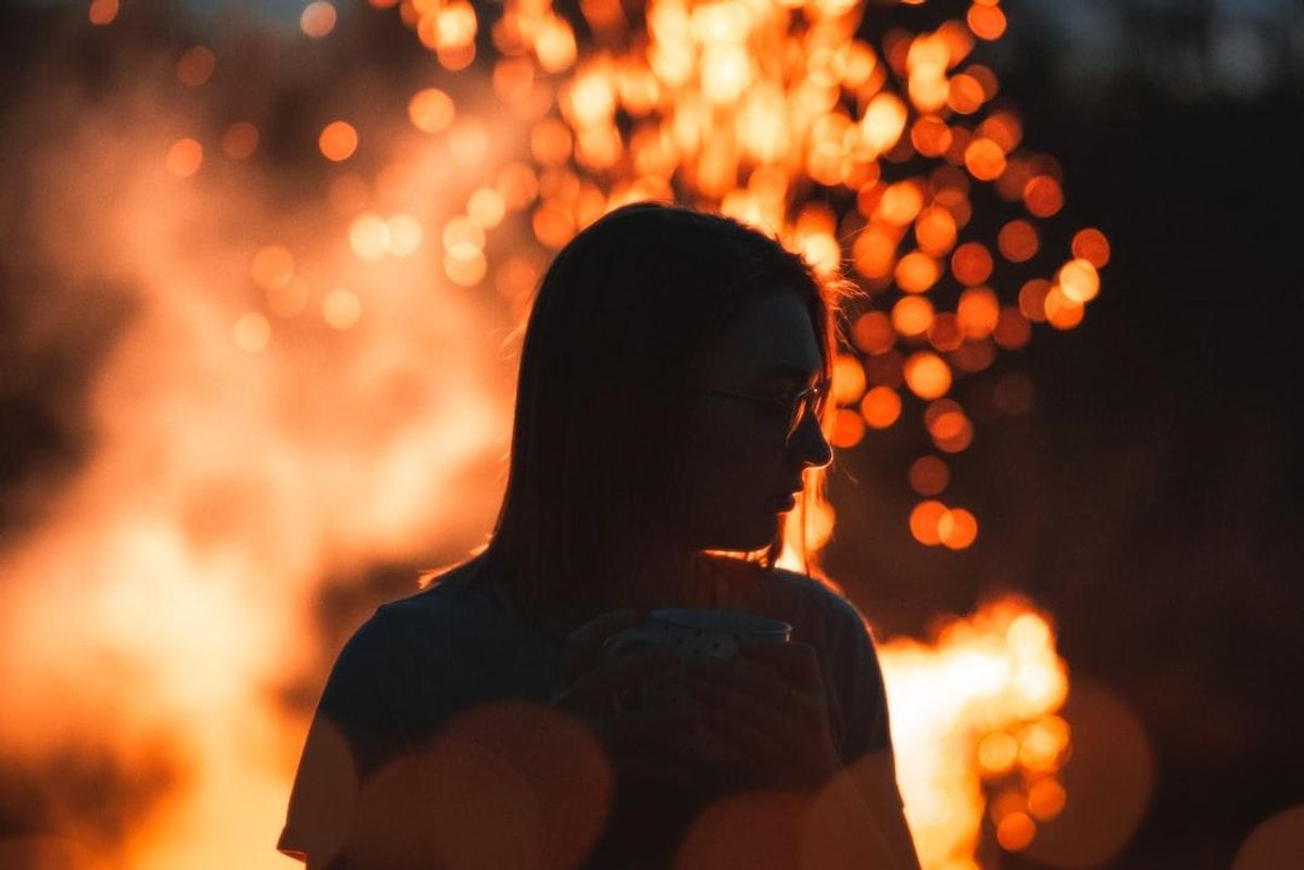 Silhouette of a person in front of sparks