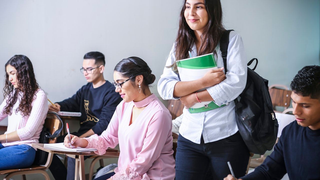 Students in a university classroom with notebooks and backpacks, preparing for the NUST NET entry test