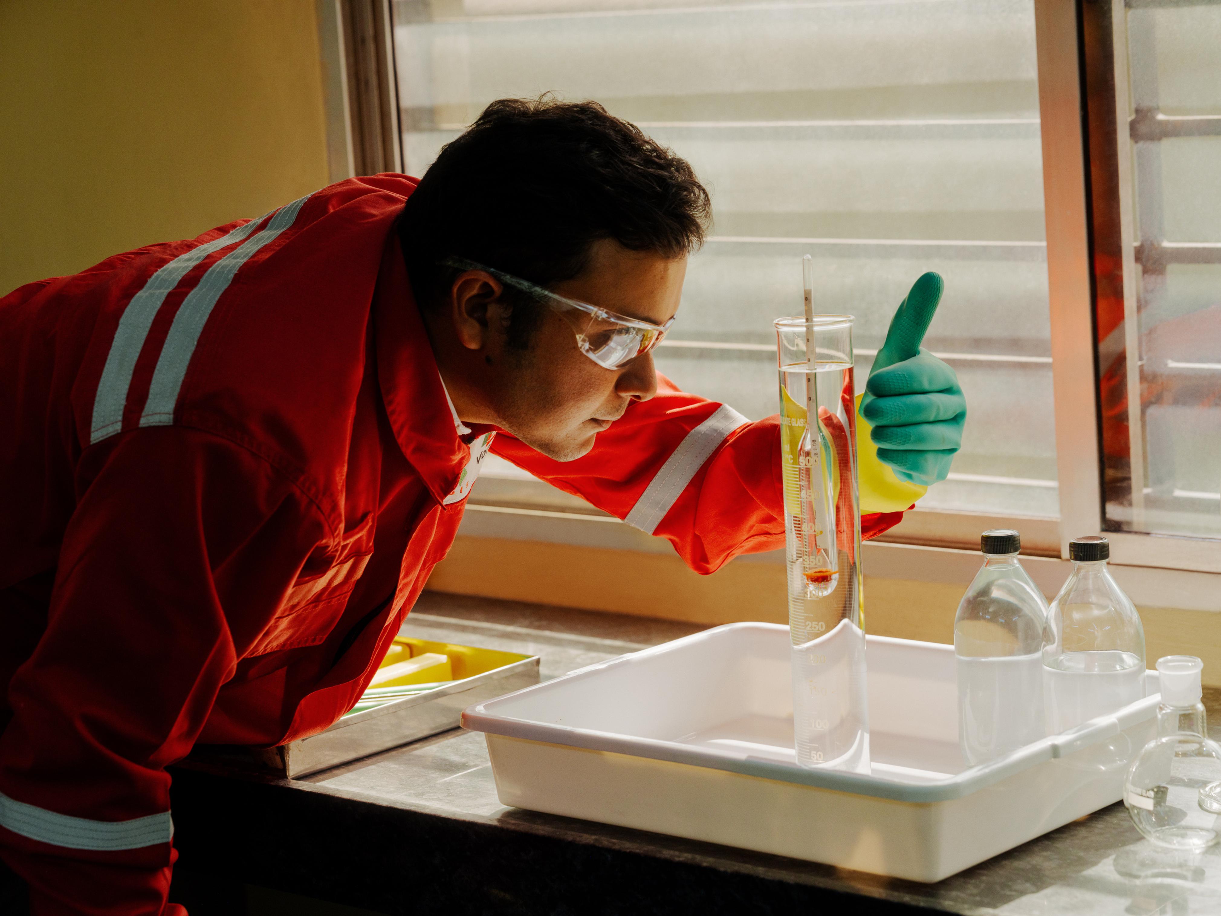 AVTL chemist examining a flask