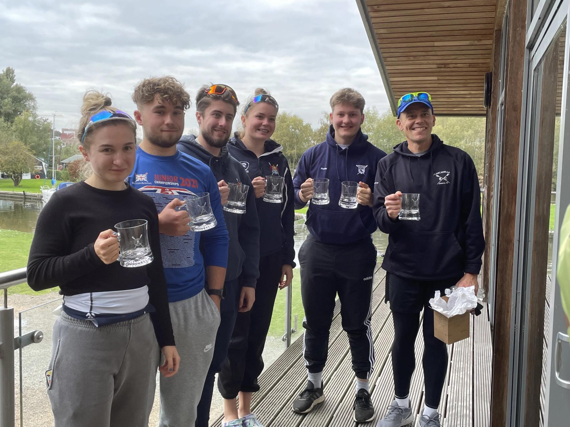 Winning scullers posing for a photograph with their glass pots in Norwich.