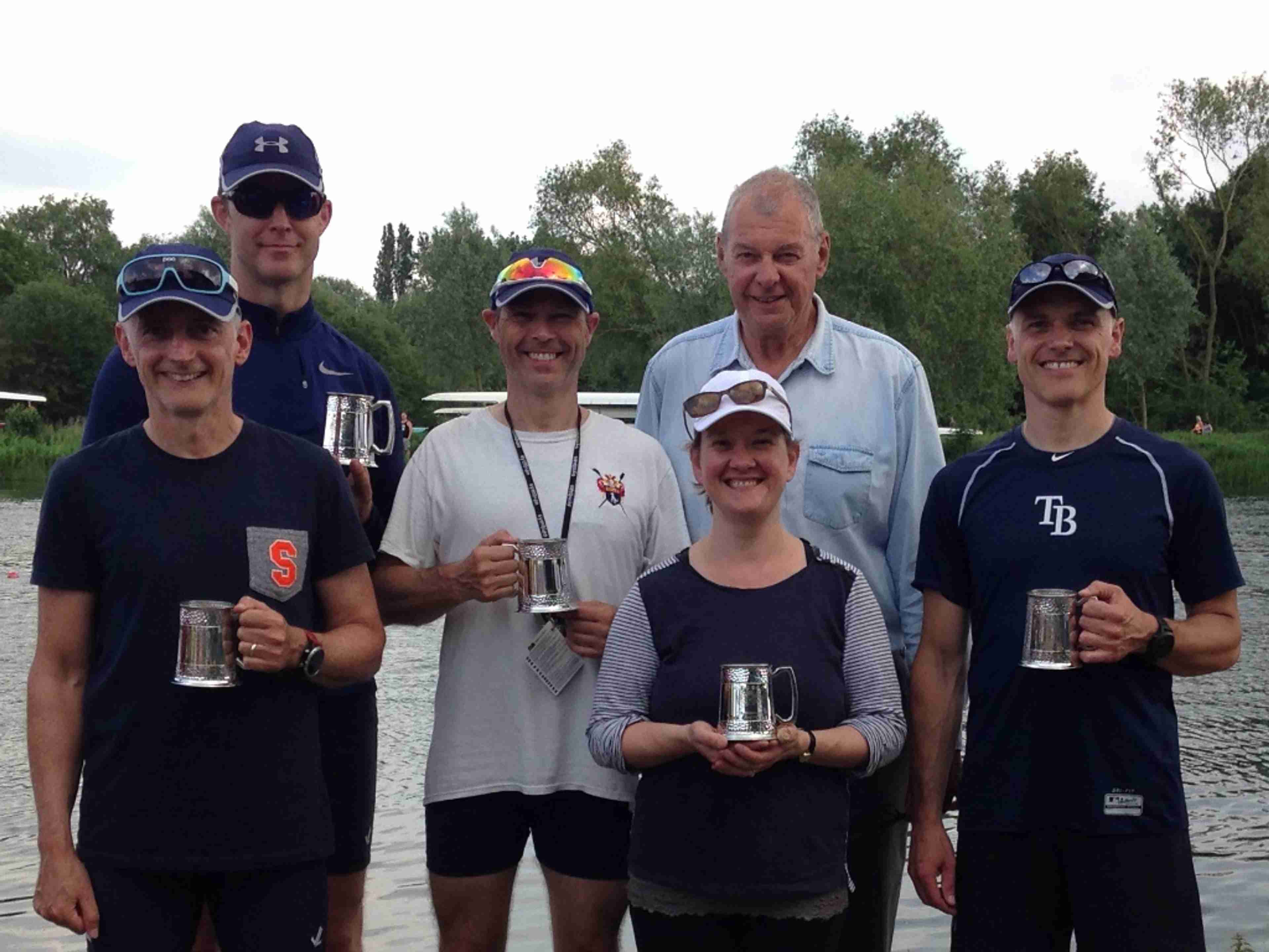 The winning men’s four, plus cox, stands with their pots. 