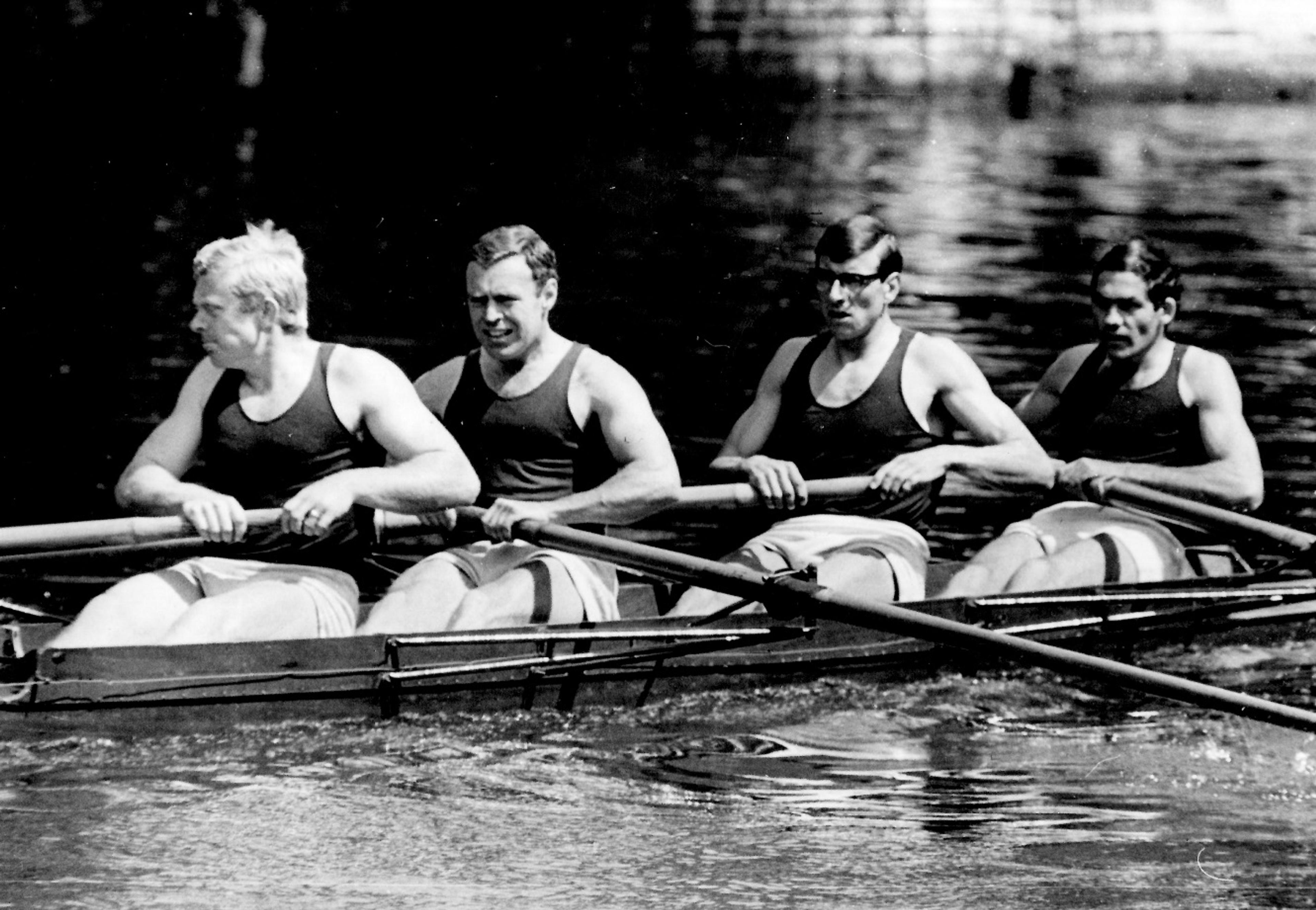 A black-and-white photograph of Bob and his crewmates rowing a four.