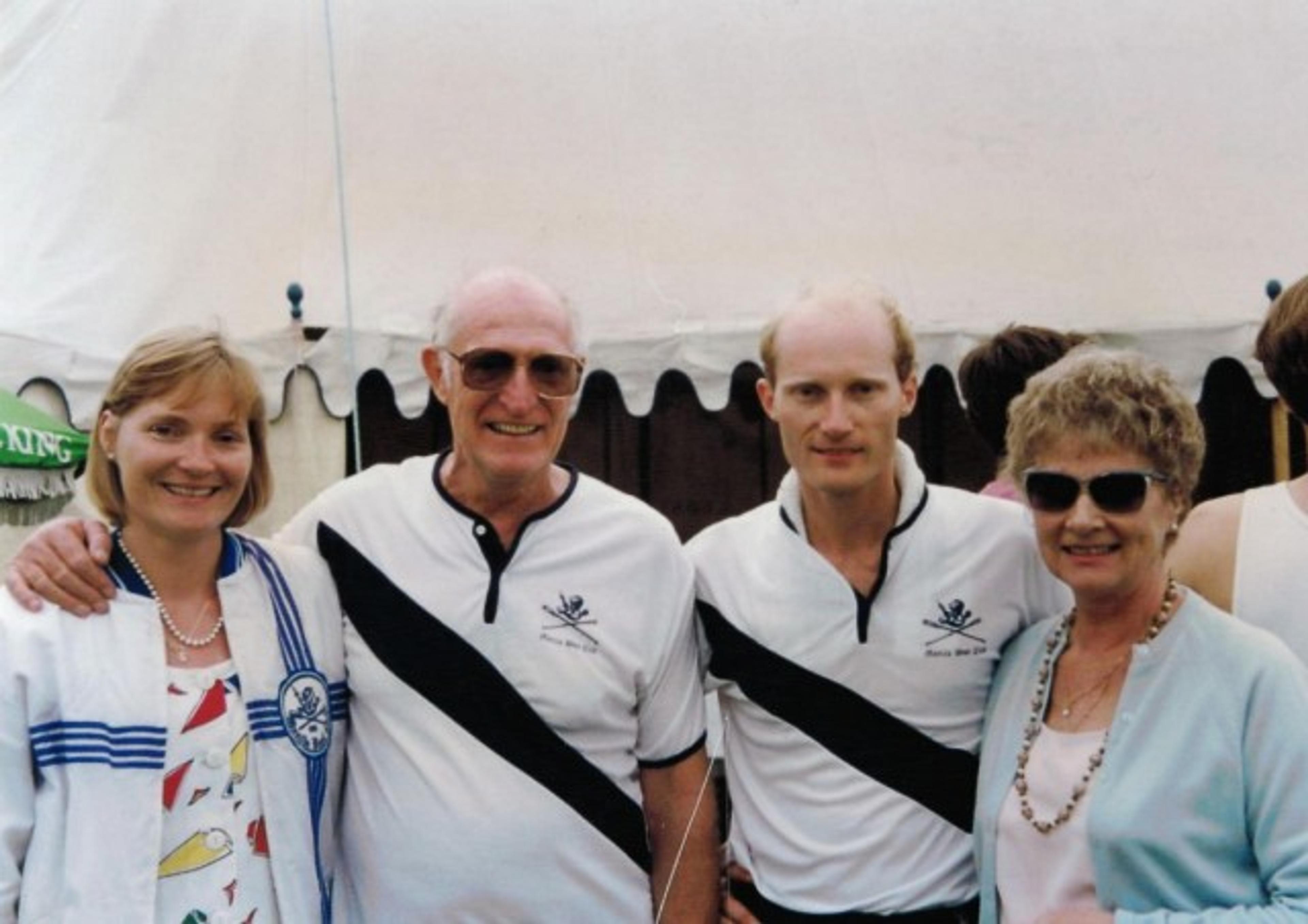 Two men in Manila Boat Club gear, flanked by two women, not in Manila Boat Club gear.