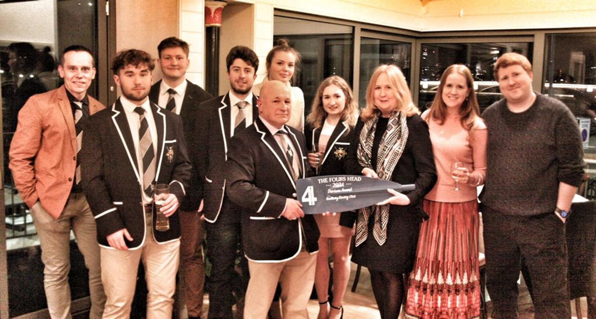 Sudbury members pose with their award, which is a painted and cut-off blade. 