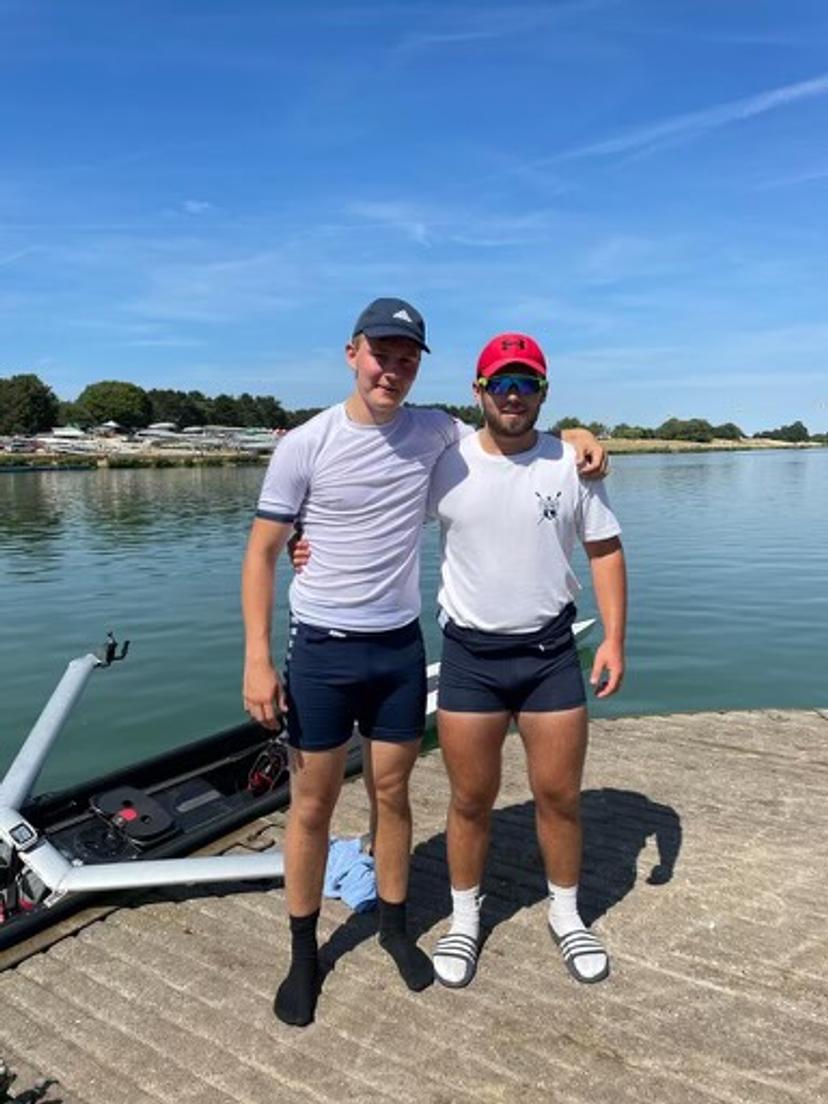 Two J17 rowers standing on the concrete landing stage at the National Water Sports Centre, Nottingham.
