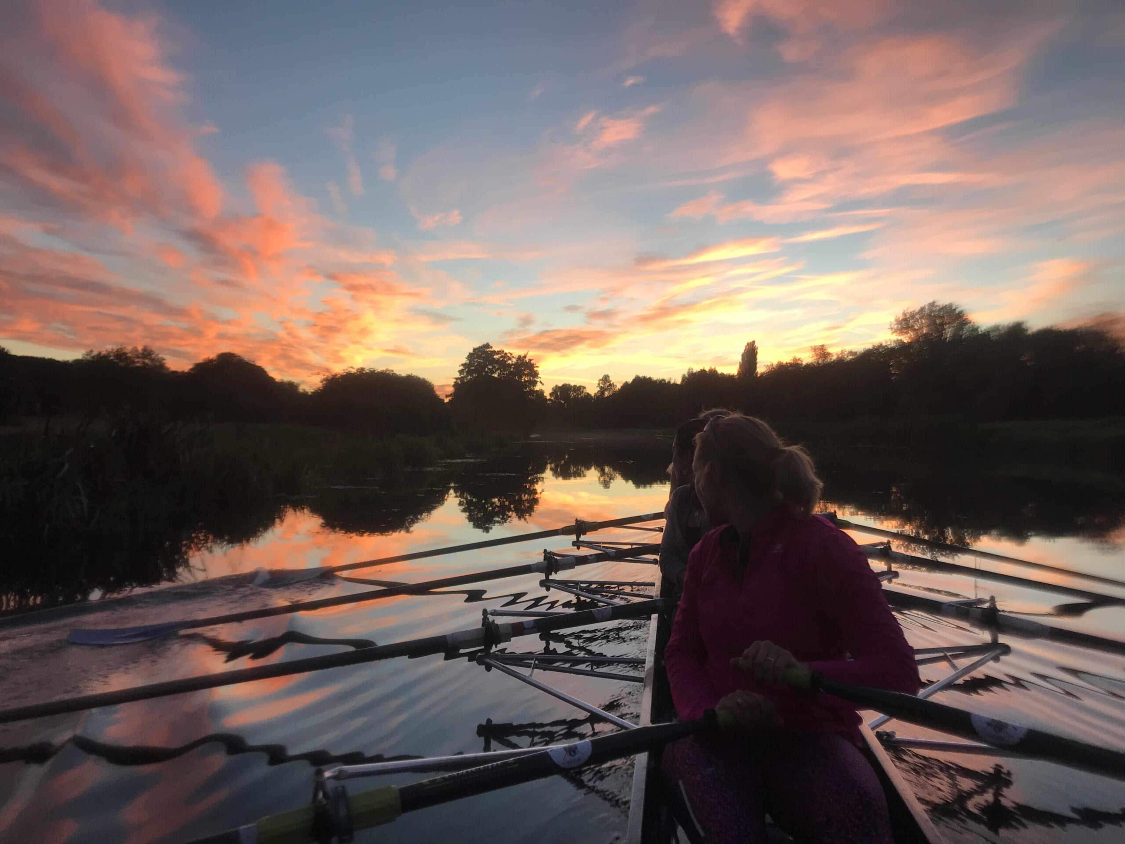 Photograph of a sunset over the water meadows, taken from the cox’s seat in a quad. 