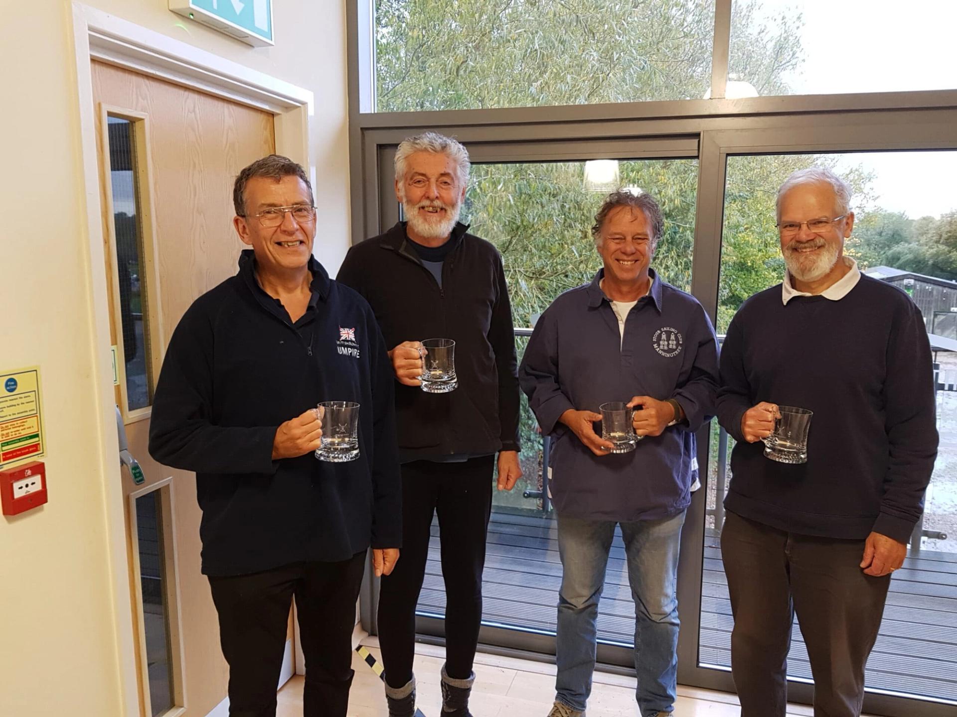 Four scullers holding their pots in Norwich.