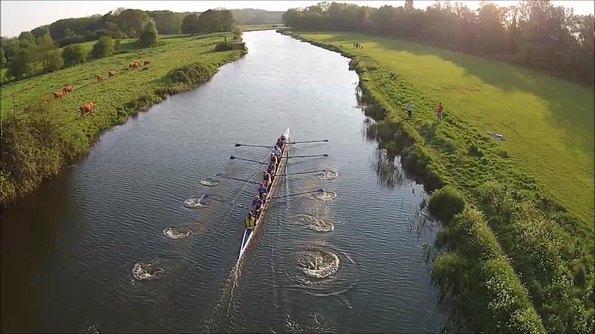 A still from the drone footage of an eight rowing down the meadow stretch of the Stour in Sudbury.