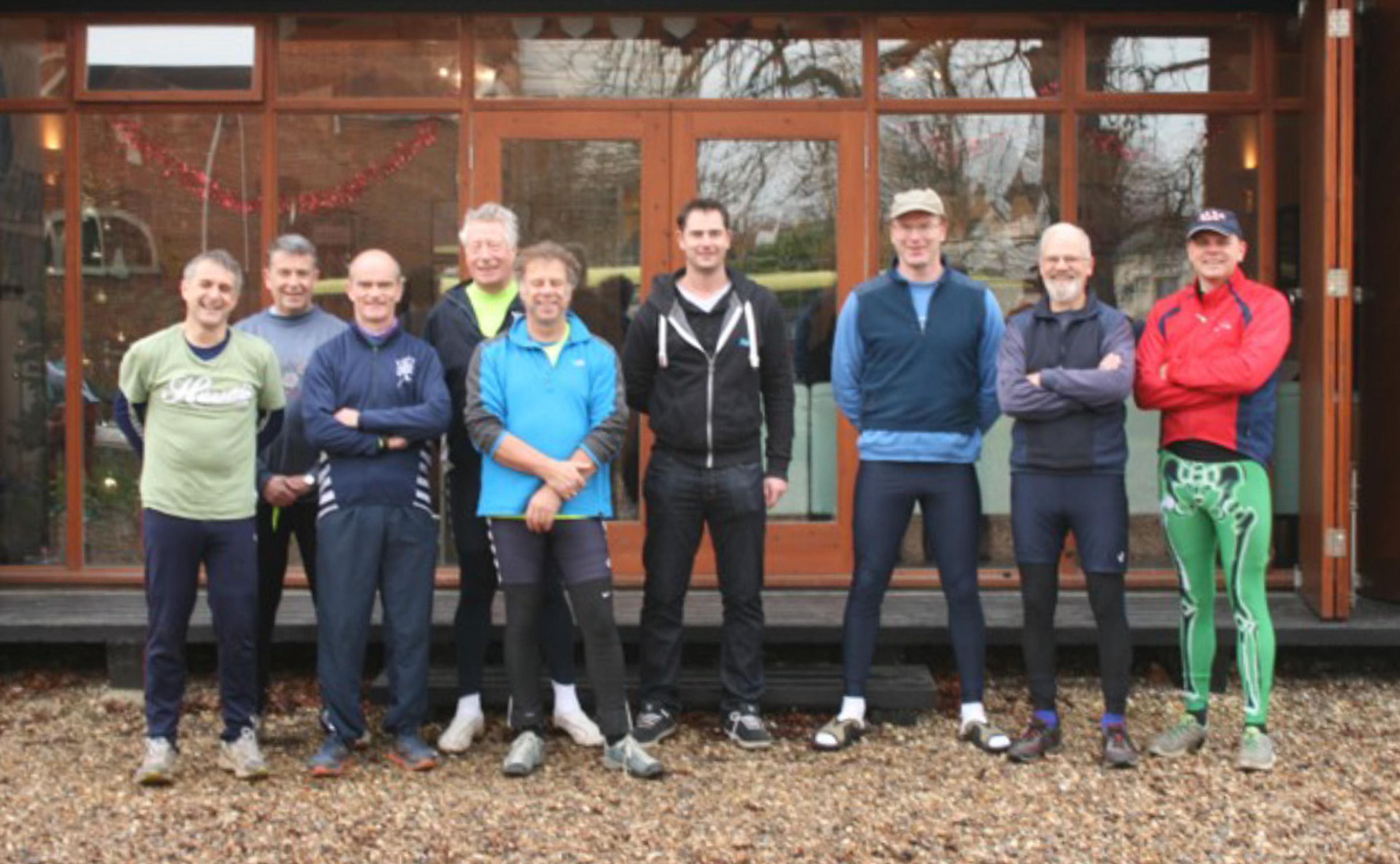 One current and eight former SRC captains pose for a photo in front of the clubhouse.
