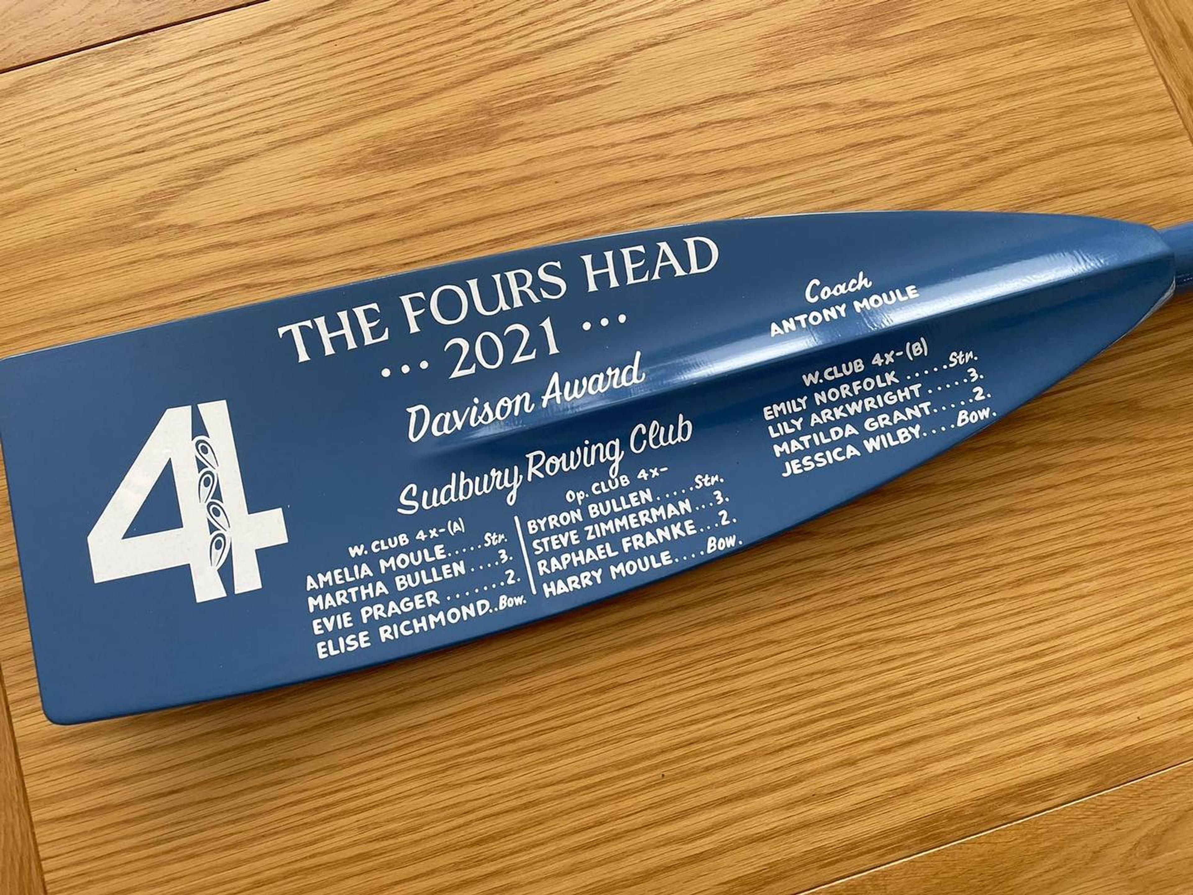 The blue award blade prize., now signwritten with the names of the winning crews.