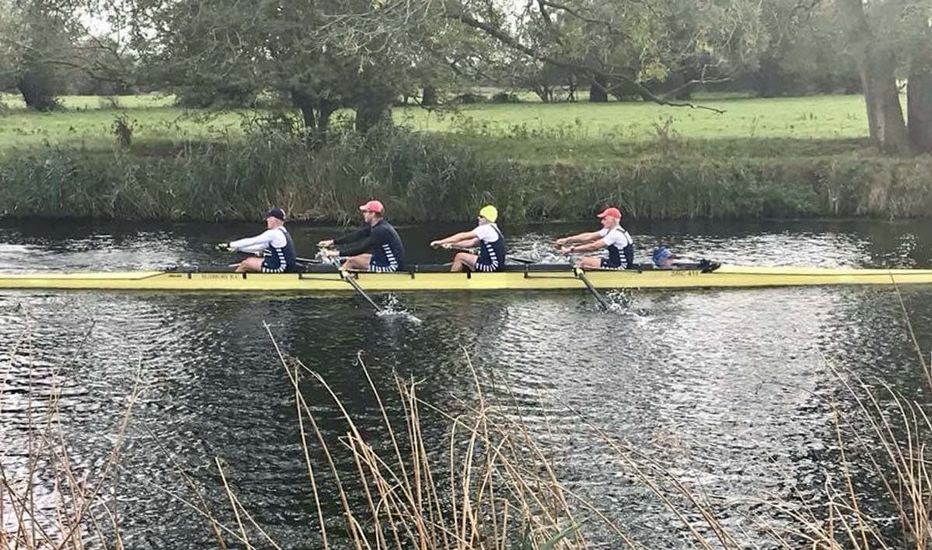 Sudbury’s winning yellow Stämpfli coxed four and its crew race past the photographer in bucolic Huntingdon.