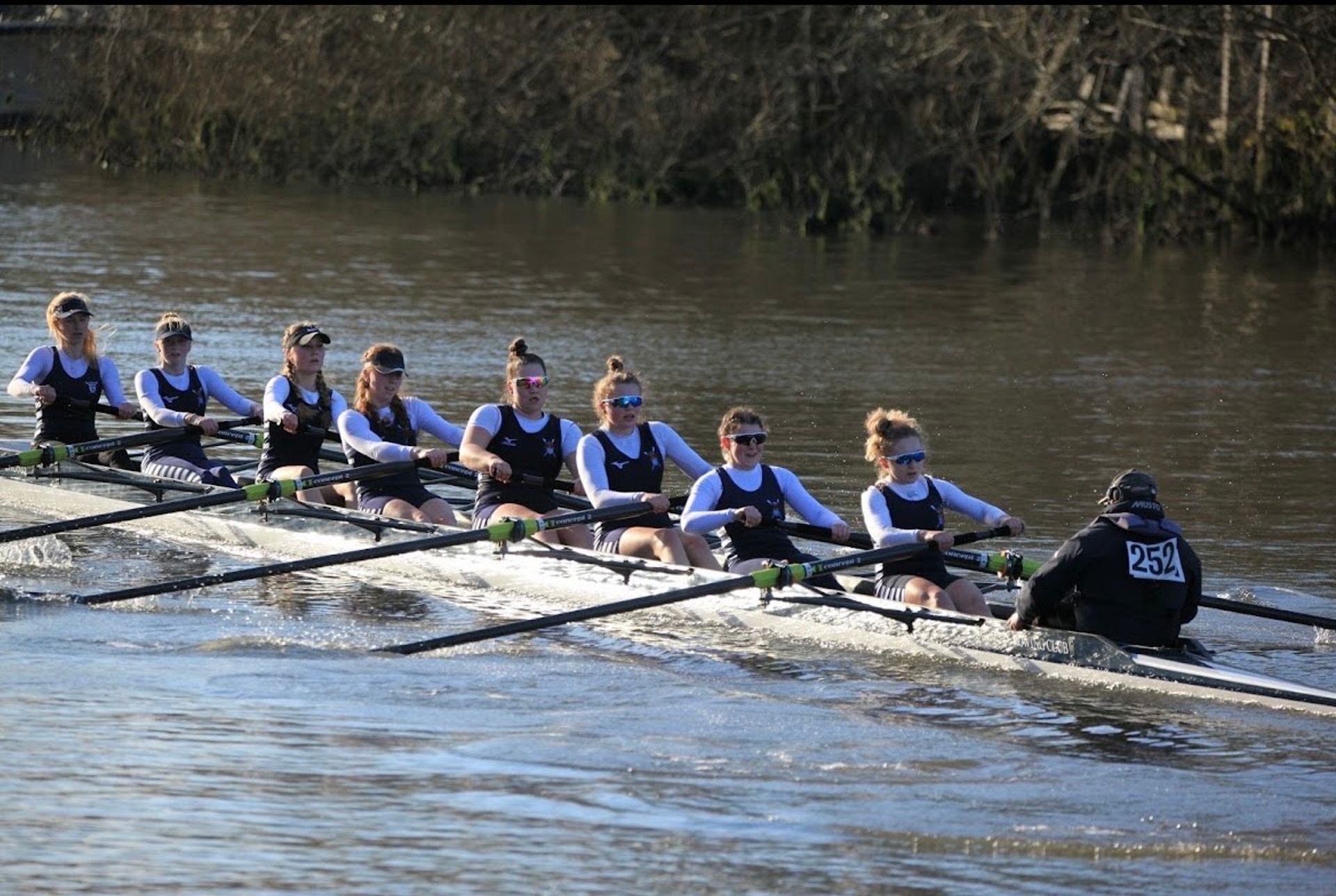 The women’s eight rowing away from the cameraman and looking quite aggressive on the Yare.