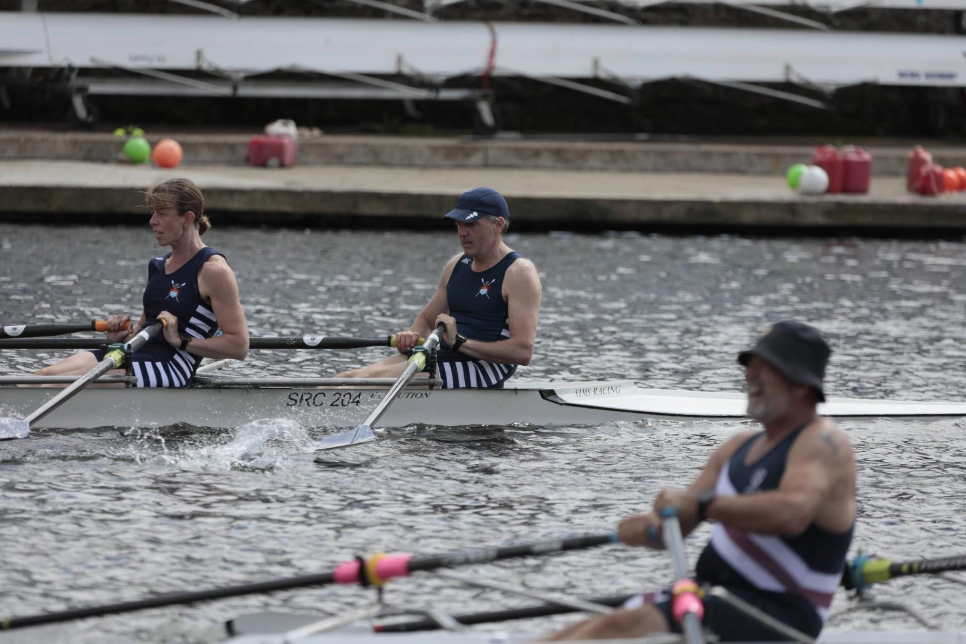 A Sudbury mixed double races over the Sunday course in comparatively good weather. Their opponents are in the foreground, blurred by lens mechanics and looking in rather poorer form.