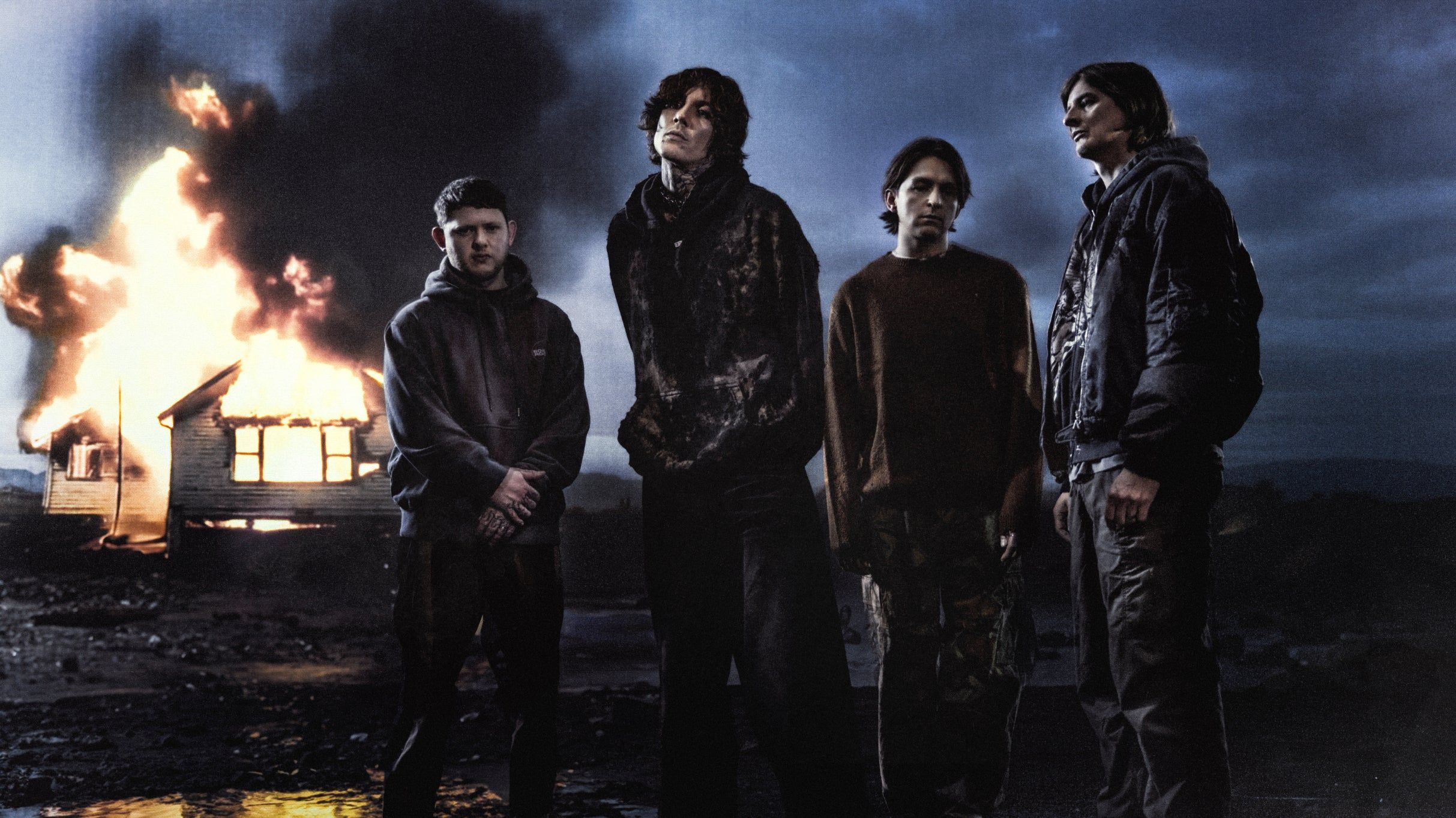 Bring Me The Horizon performing live on stage with dramatic lighting
