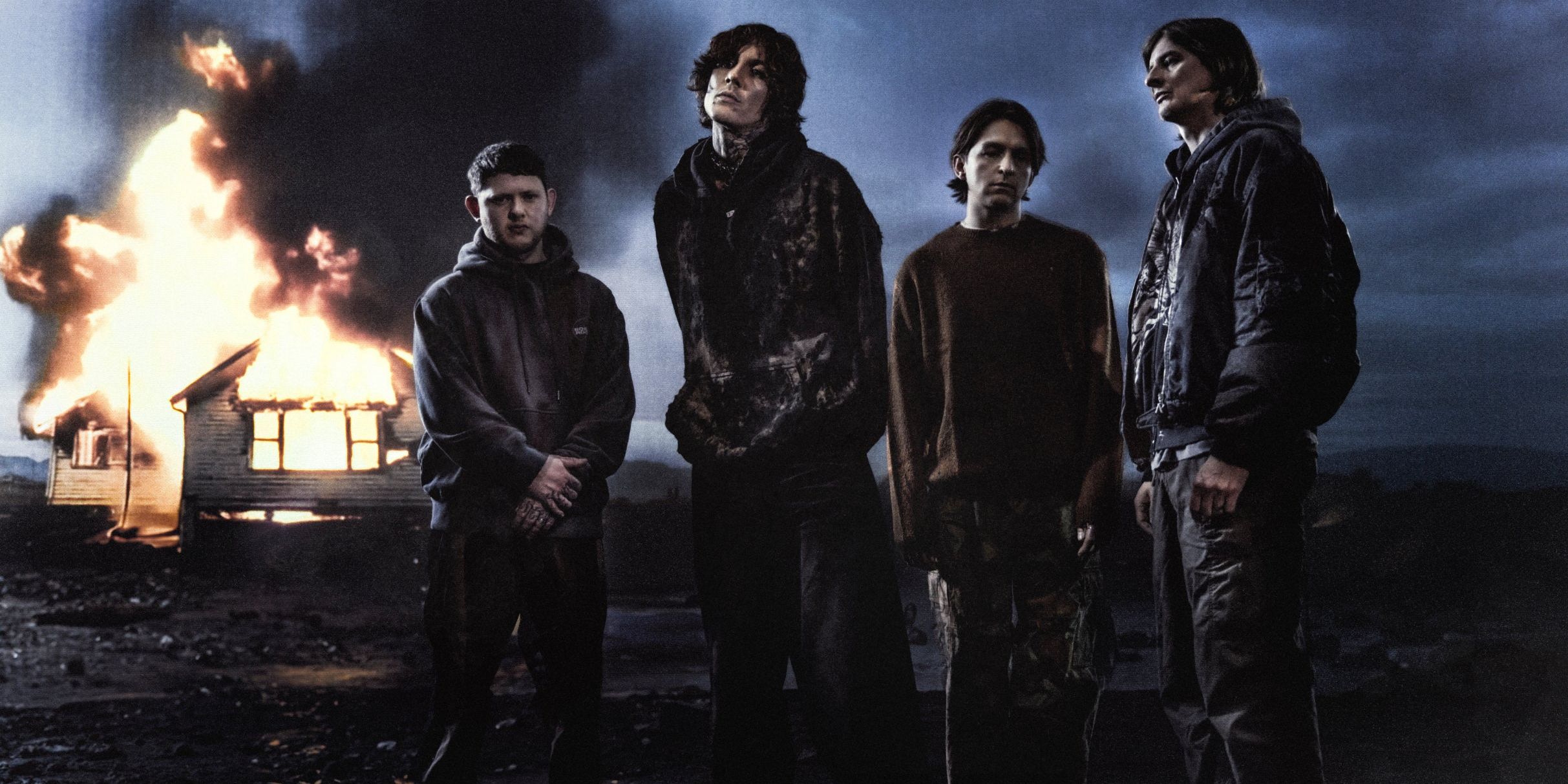 Bring Me The Horizon performing live on stage with dramatic lighting
