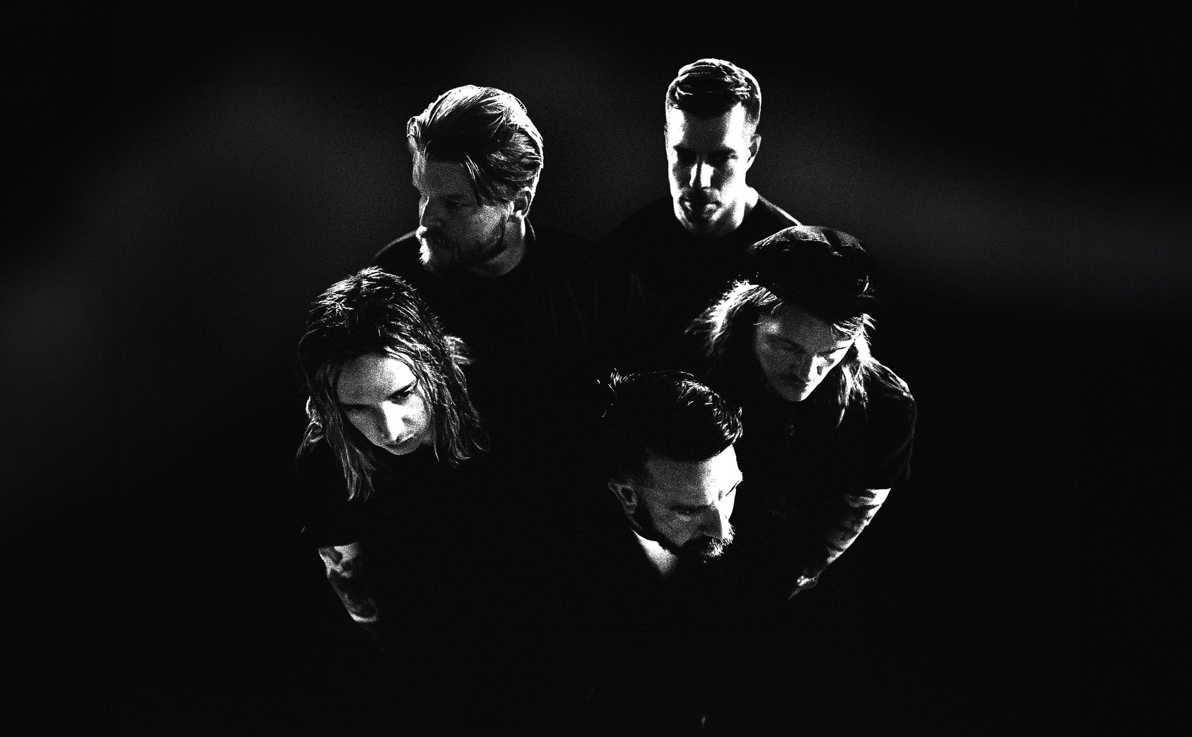 Underoath performing live on stage during an intense post-hardcore set