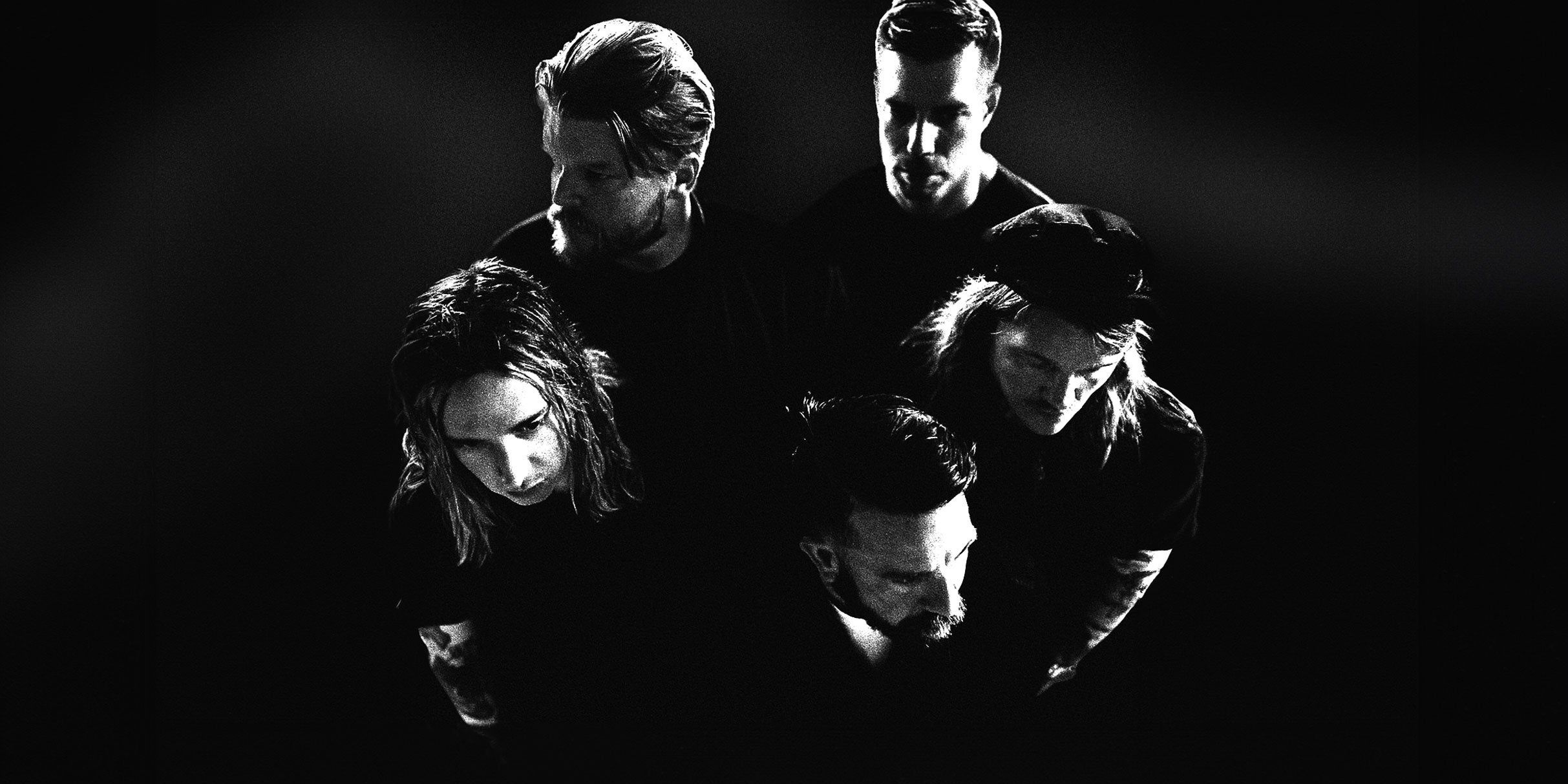 Underoath performing live on stage during an intense post-hardcore set