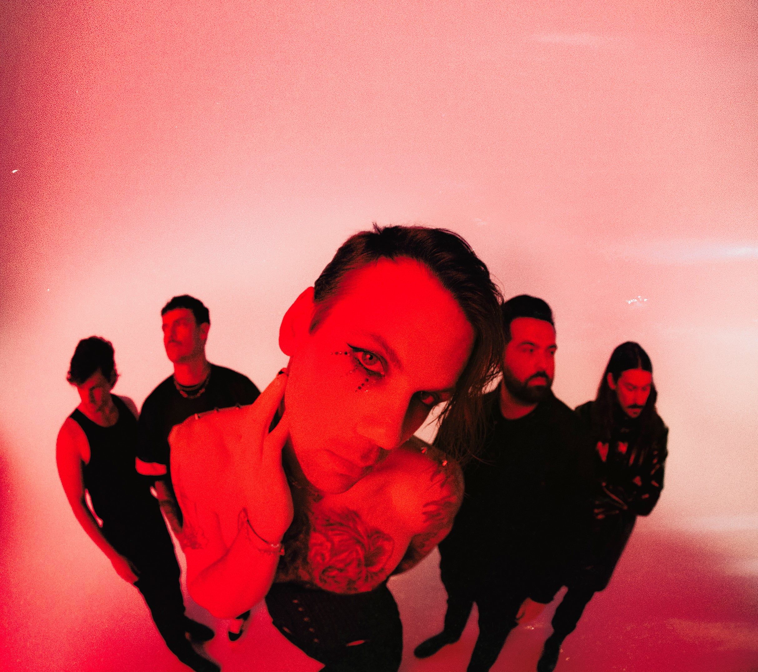 Beartooth promotional photo with dramatic red lighting featuring Caleb Shomo and the band