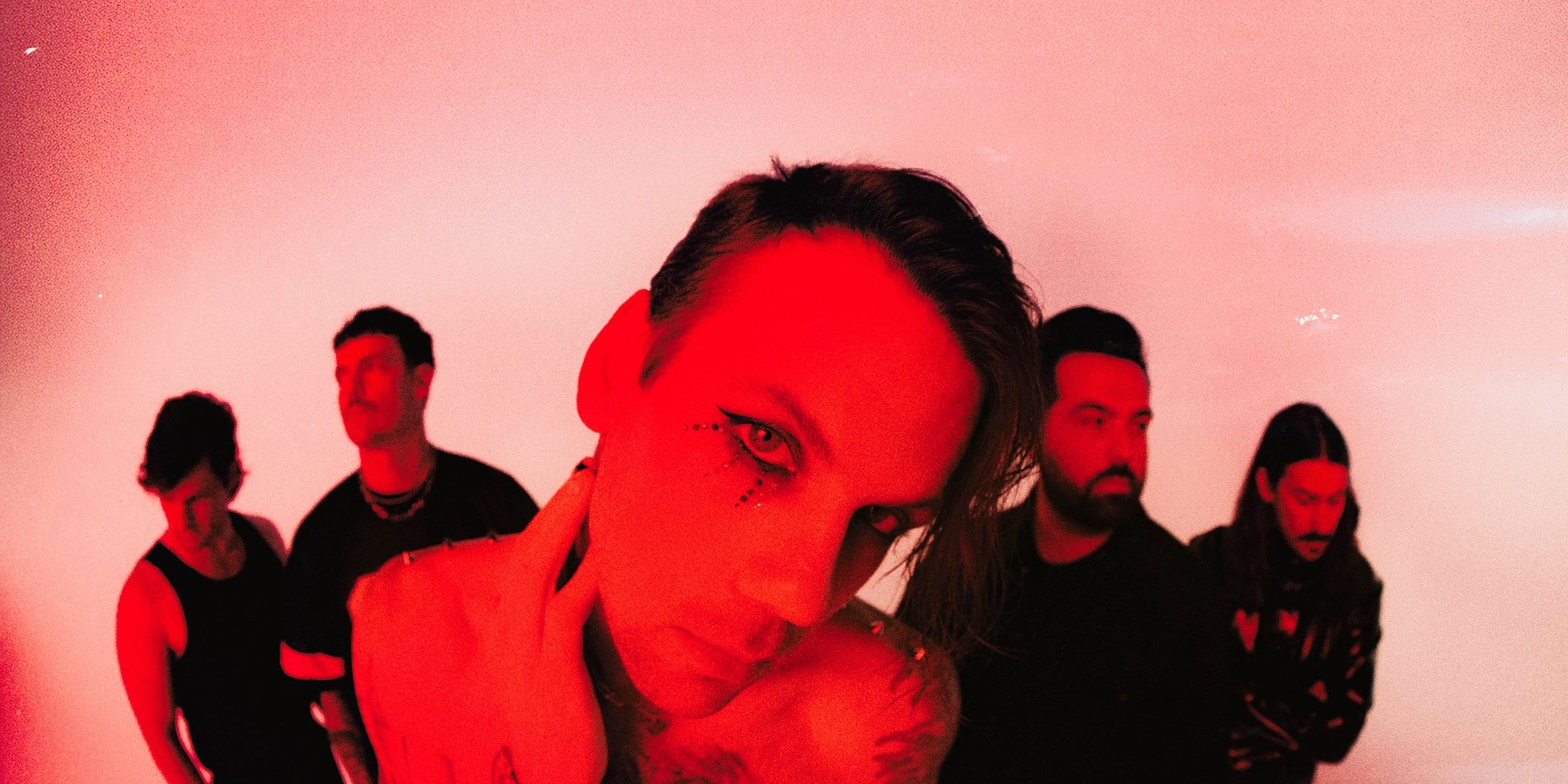 Beartooth promotional photo with dramatic red lighting featuring Caleb Shomo and the band
