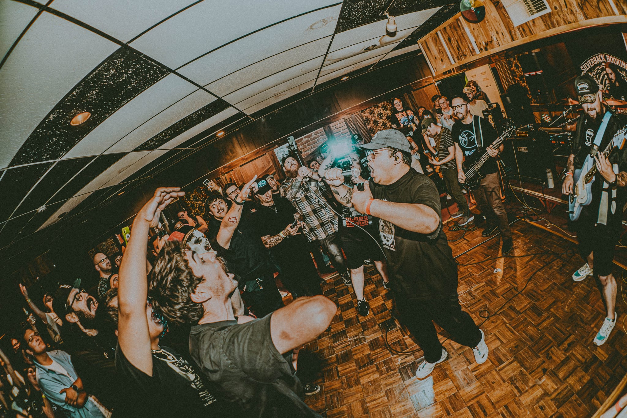 Fox Thoughts vocalist Laxon screaming into a packed DIY crowd