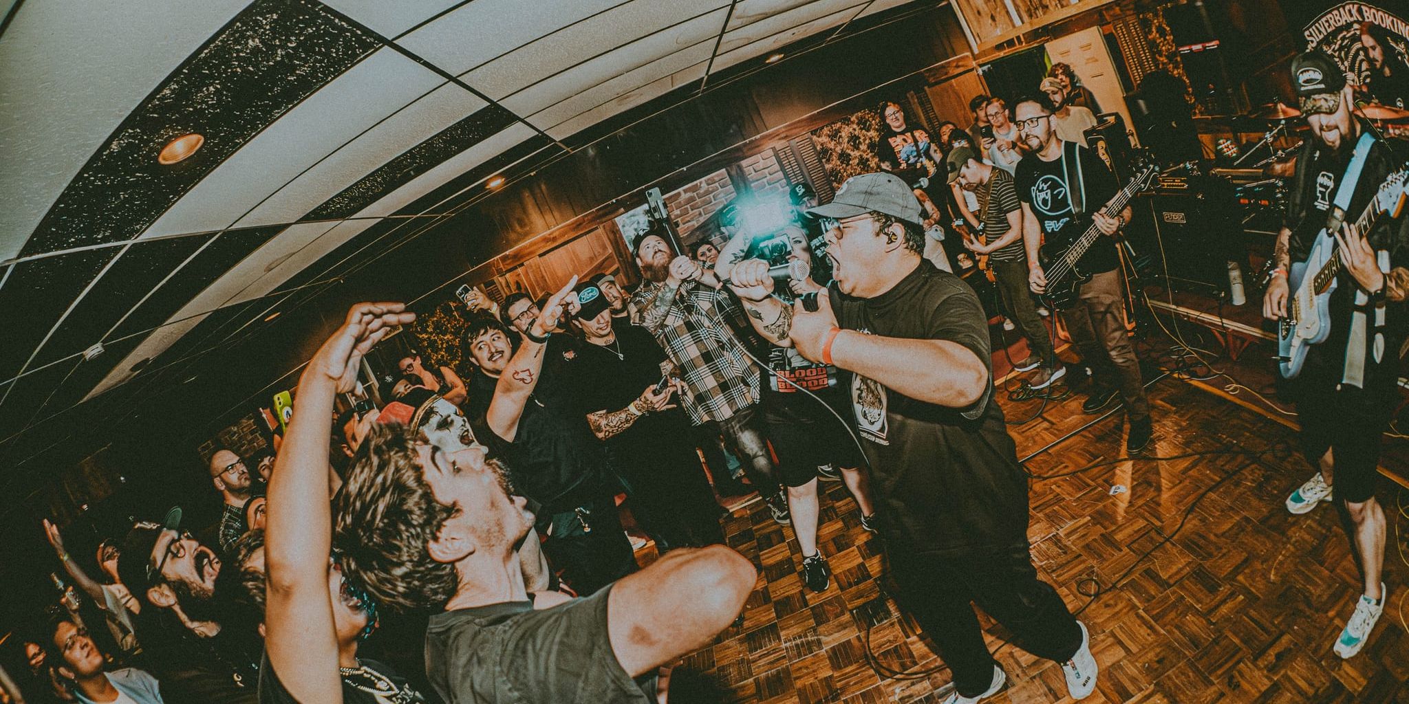 Fox Thoughts vocalist Laxon screaming into a packed DIY crowd
