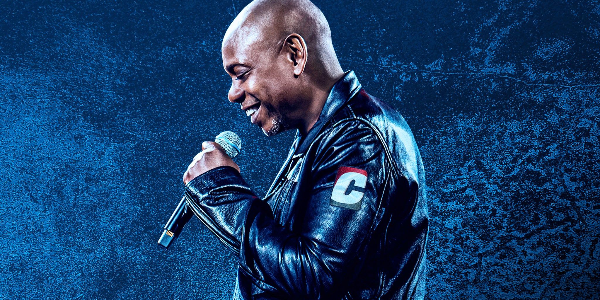 Dave Chappelle performing live on stage during his 2026 summer arena tour
