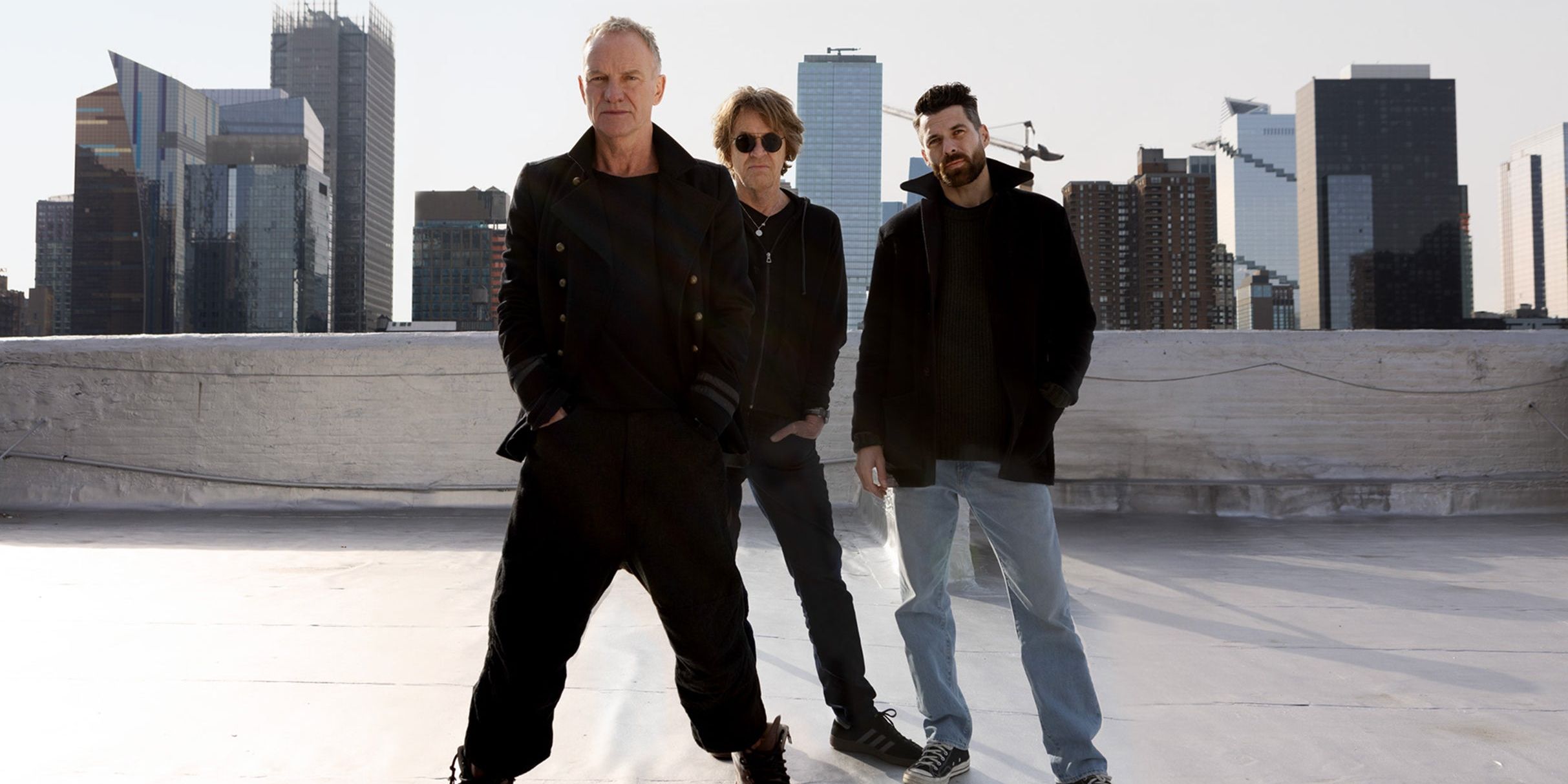 Sting performing live on stage with bass guitar