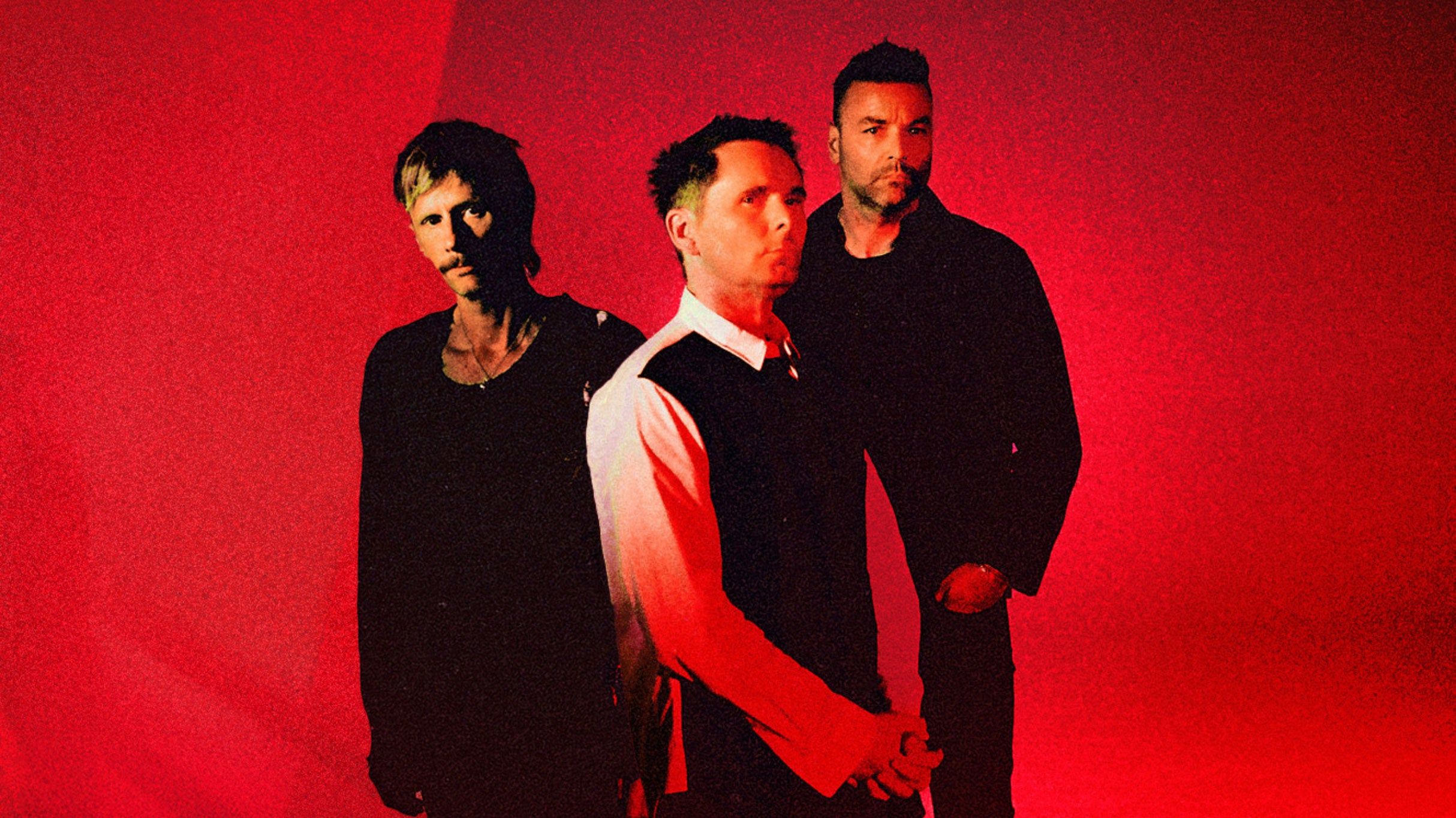 Muse performing live on stage during a concert